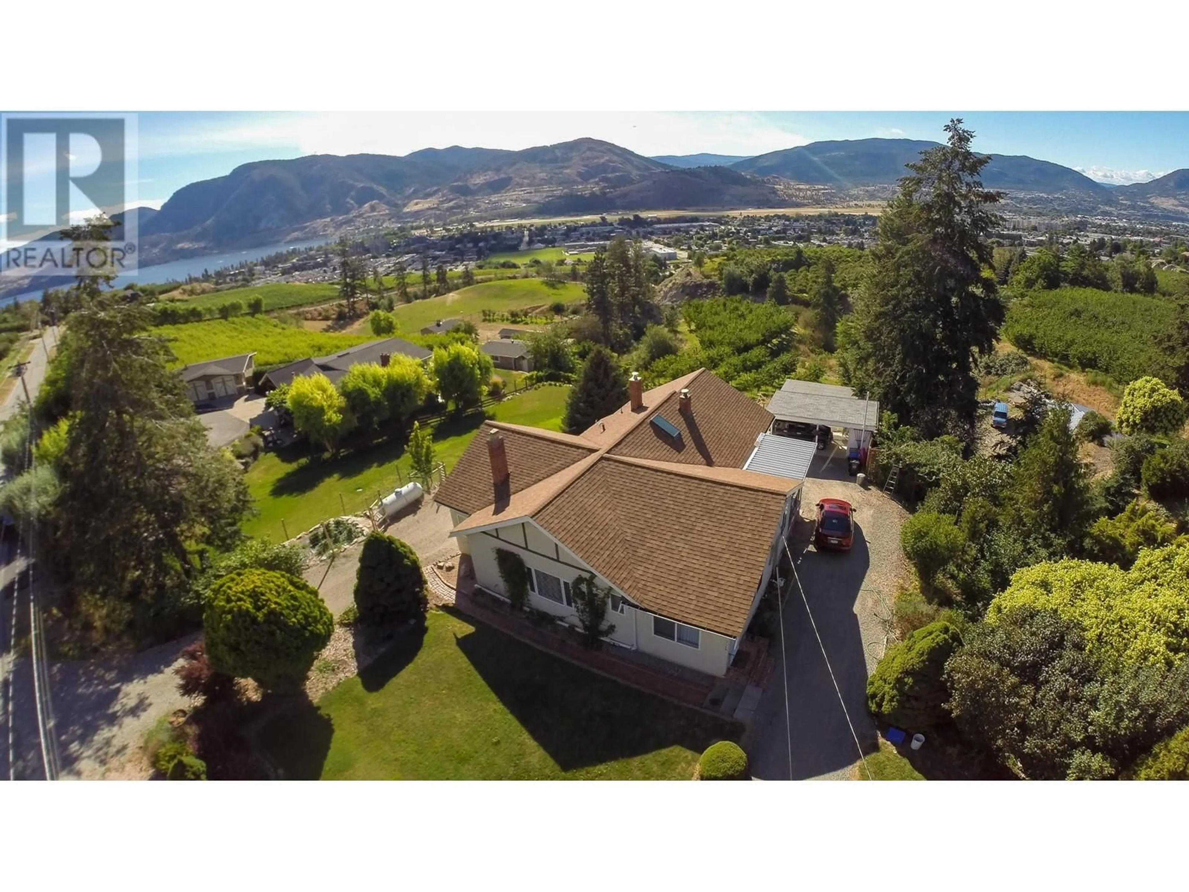 A pic from outside/outdoor area/front of a property/back of a property/a pic from drone, mountain view for 3045 VALLEYVIEW ROAD, Penticton British Columbia V2A8W8