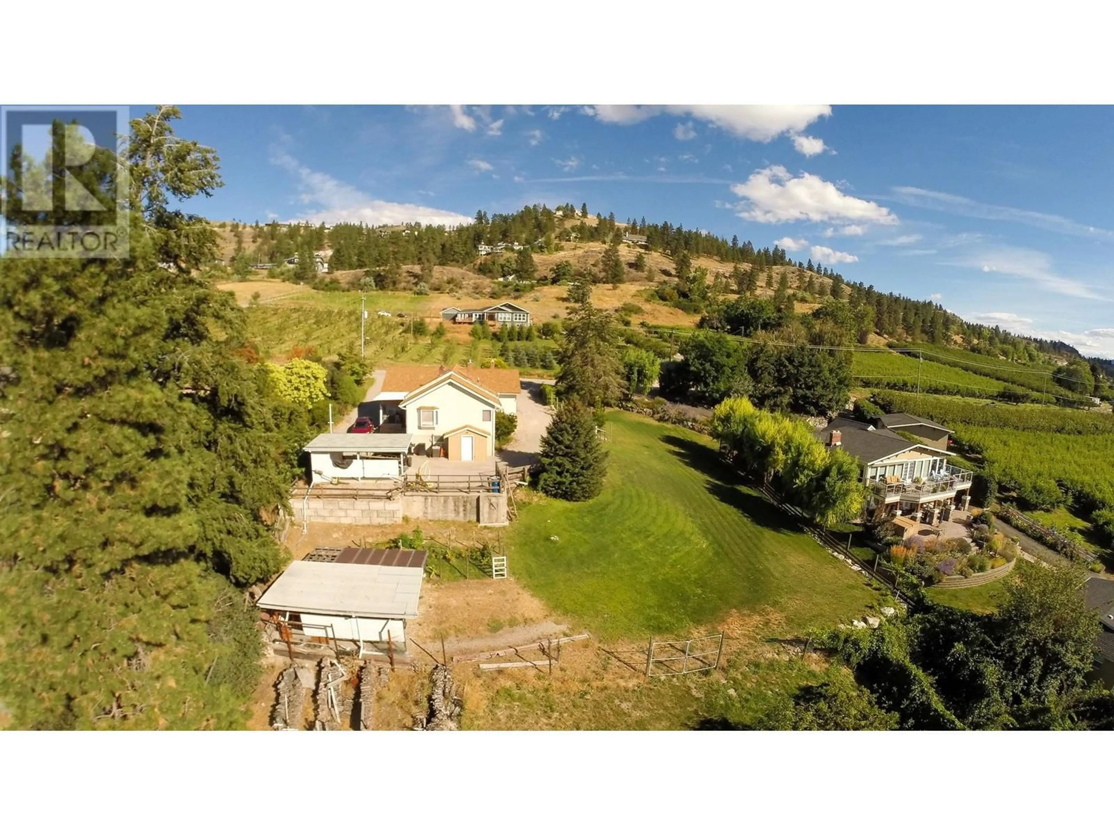 A pic from outside/outdoor area/front of a property/back of a property/a pic from drone, mountain view for 3045 VALLEYVIEW ROAD, Penticton British Columbia V2A8W8