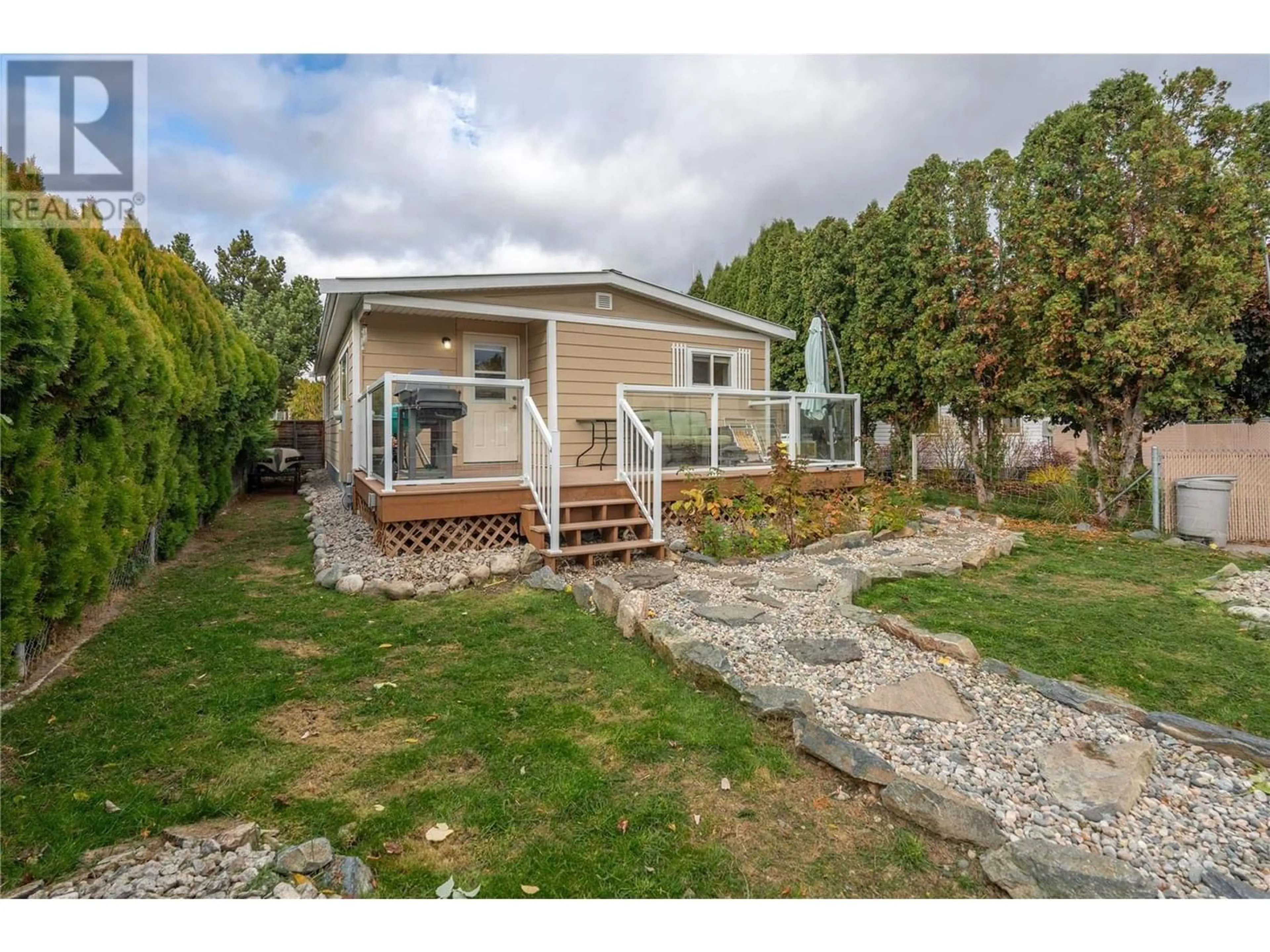 Frontside or backside of a home, the fenced backyard for 4740 Mimac Court, Okanagan Falls British Columbia V0H1R2