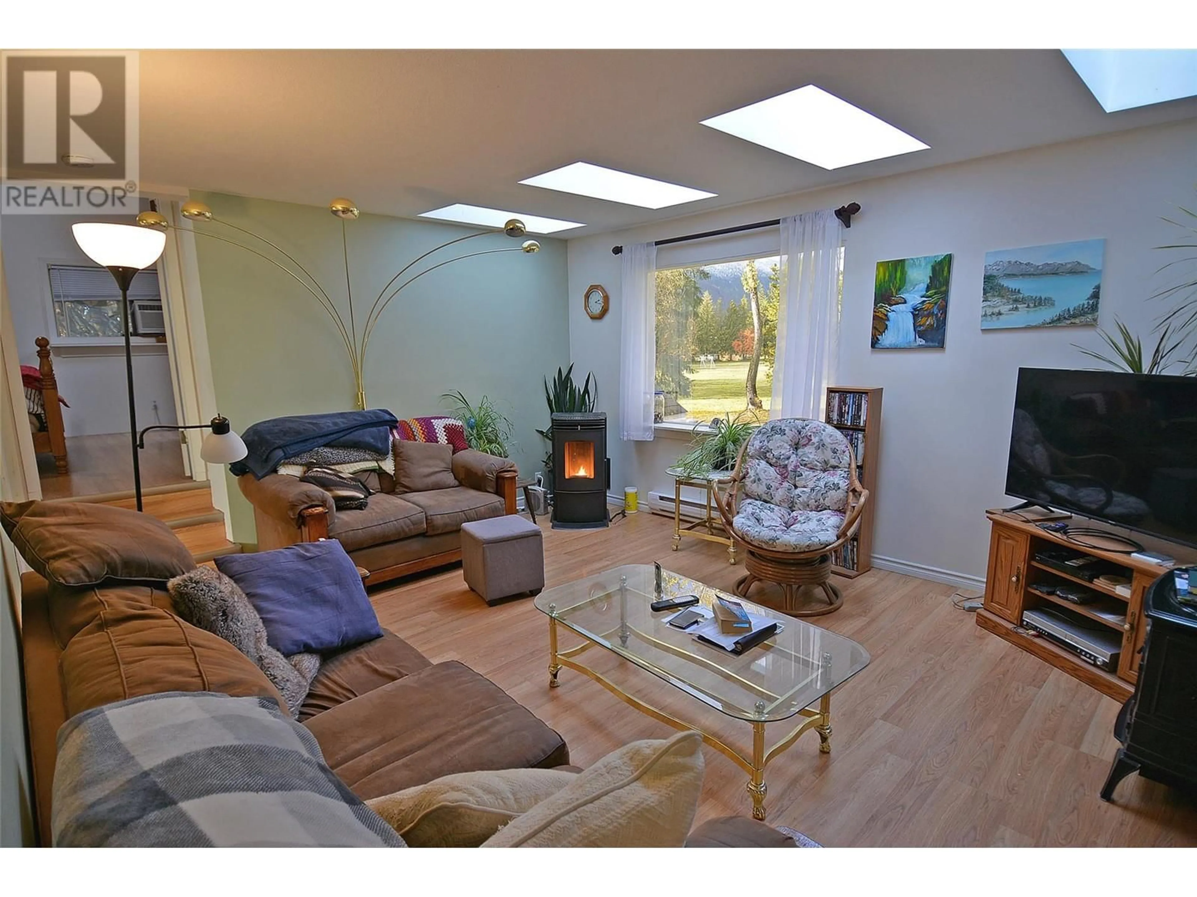 Living room with furniture, wood/laminate floor for 705 GIFFIN AVENUE, Slocan British Columbia V0G2C0
