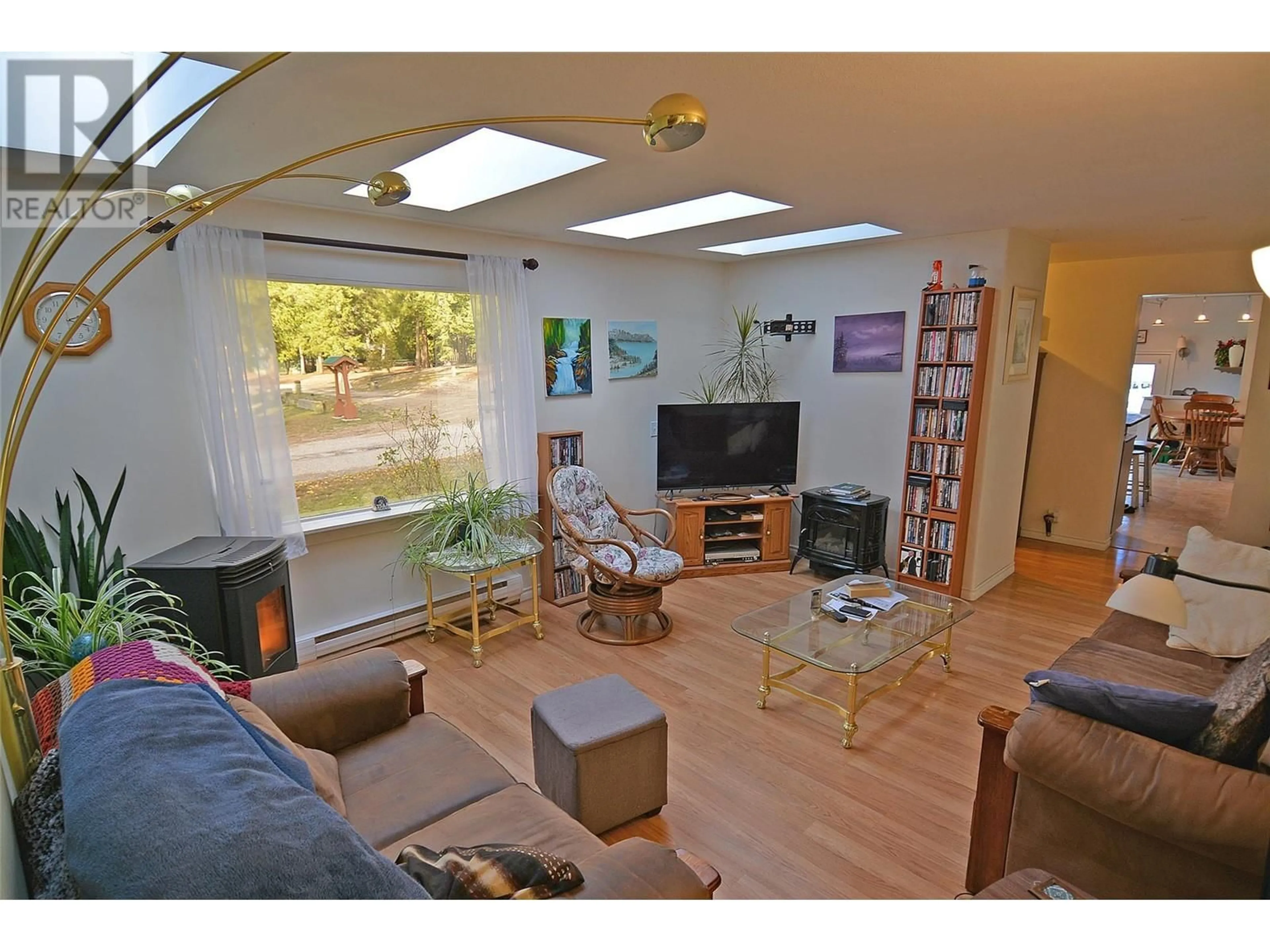 Living room with furniture, wood/laminate floor for 705 GIFFIN AVENUE, Slocan British Columbia V0G2C0