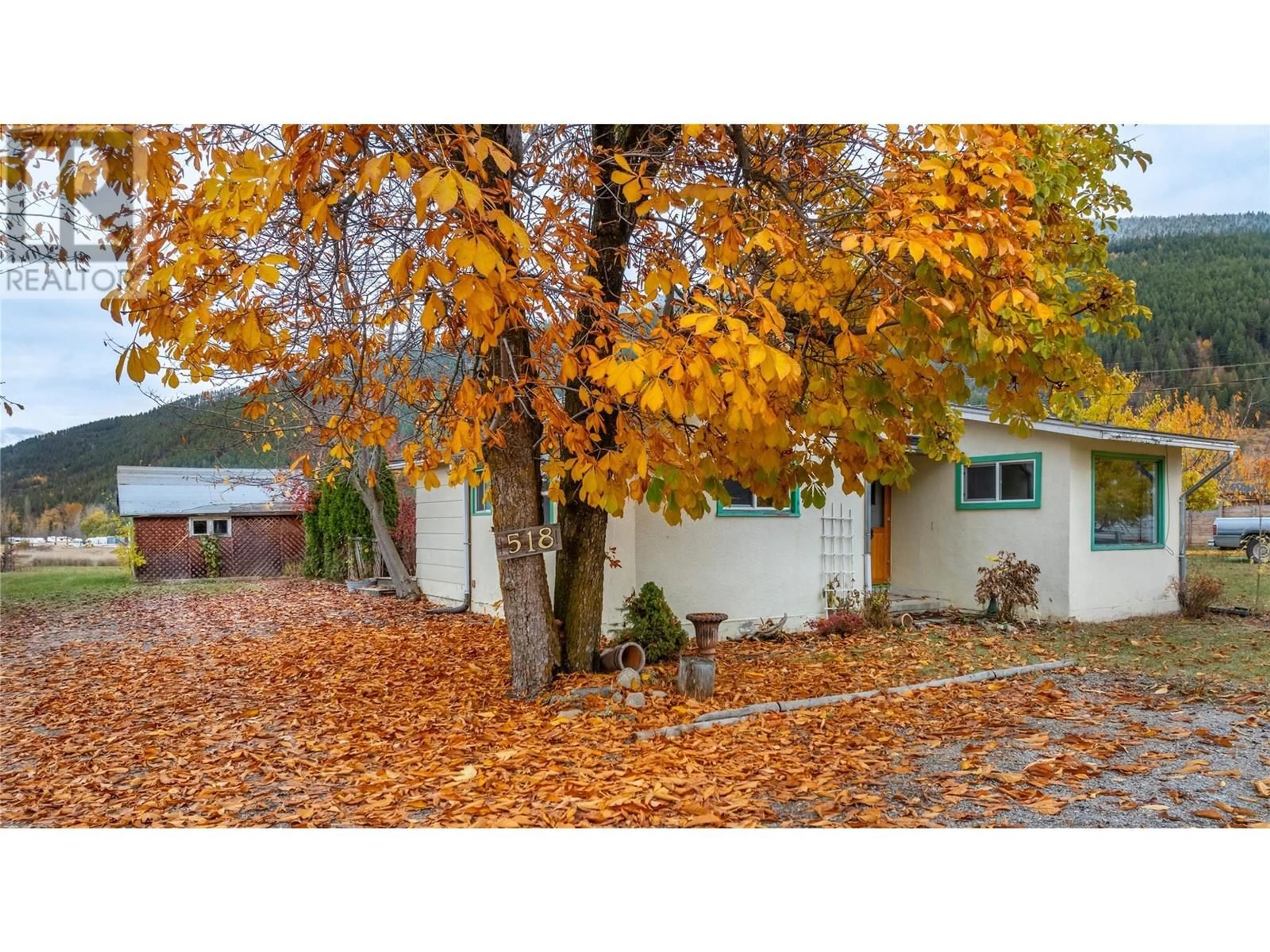 Frontside or backside of a home, the fenced backyard for 518 Devon Street, Creston British Columbia V0B1G3