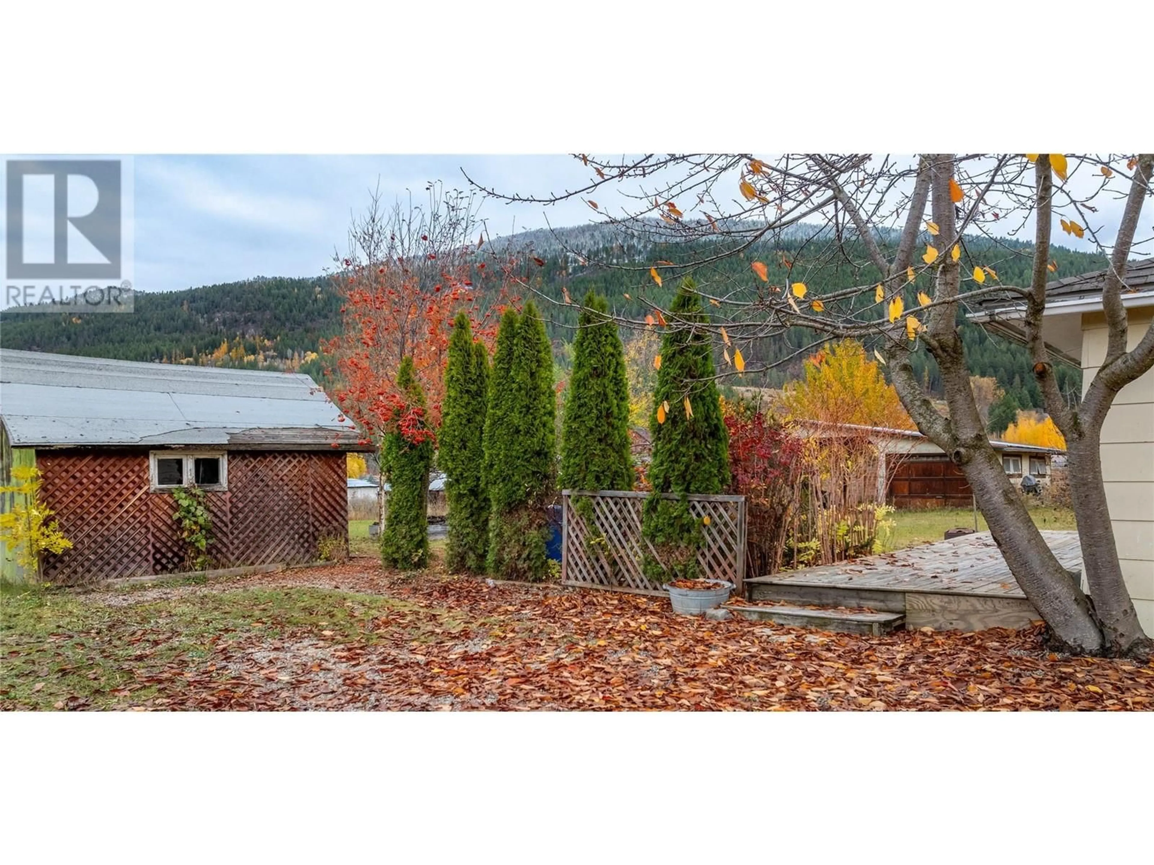 Frontside or backside of a home, the fenced backyard for 518 Devon Street, Creston British Columbia V0B1G3