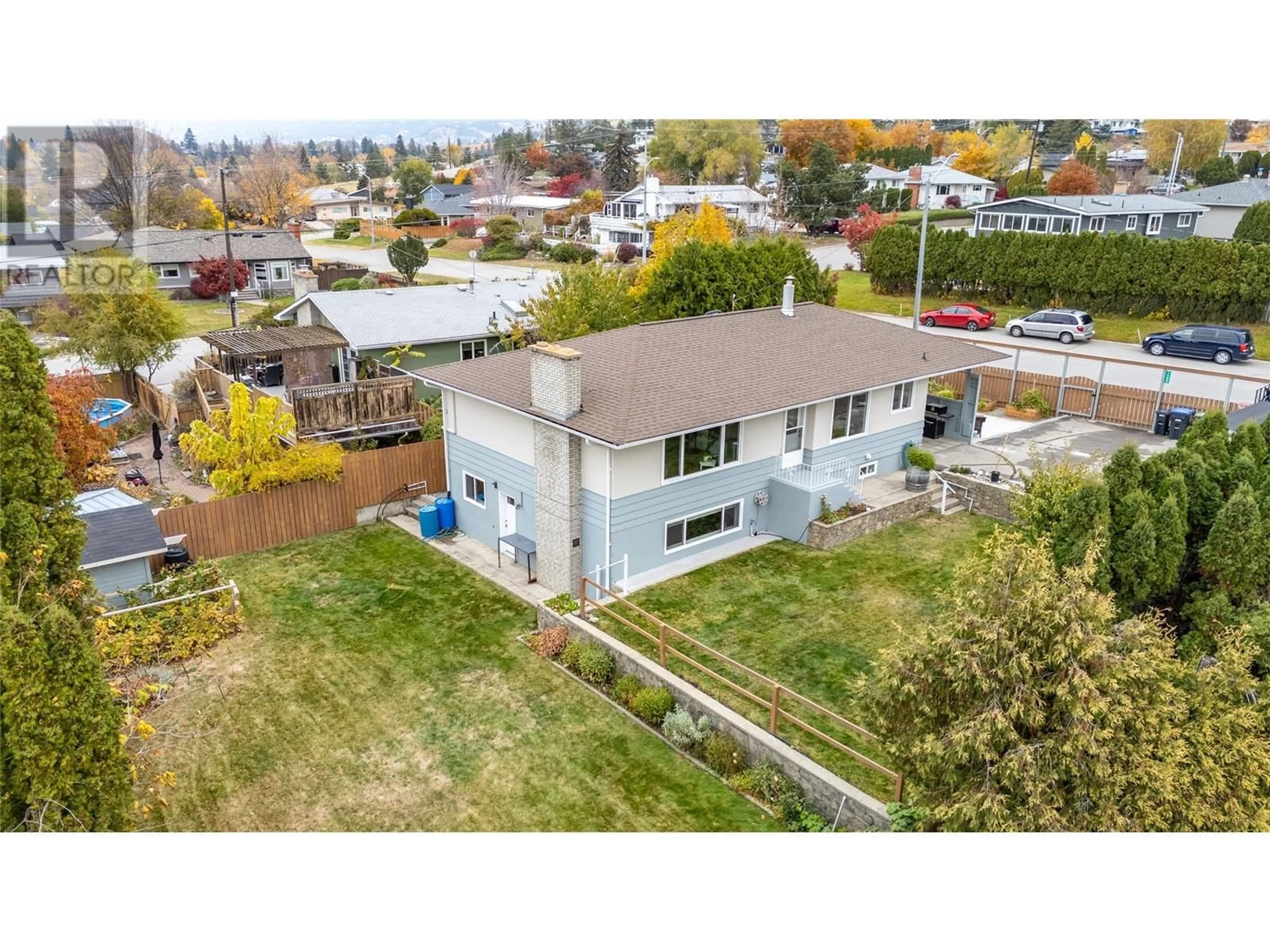 Frontside or backside of a home, the fenced backyard for 1465 Dartmouth Street, Penticton British Columbia V2A4B7