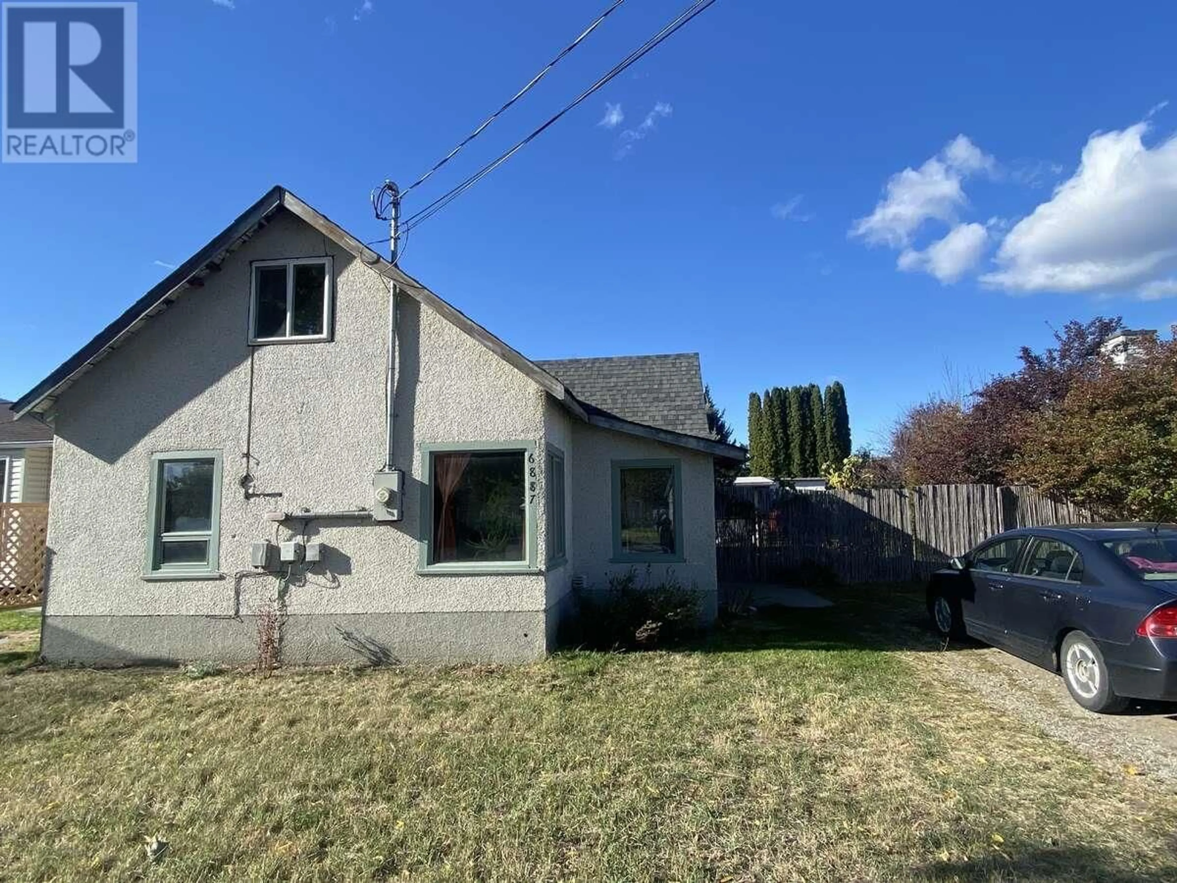 Frontside or backside of a home, the fenced backyard for 6887 16th Street, Grand Forks British Columbia V0H1H0