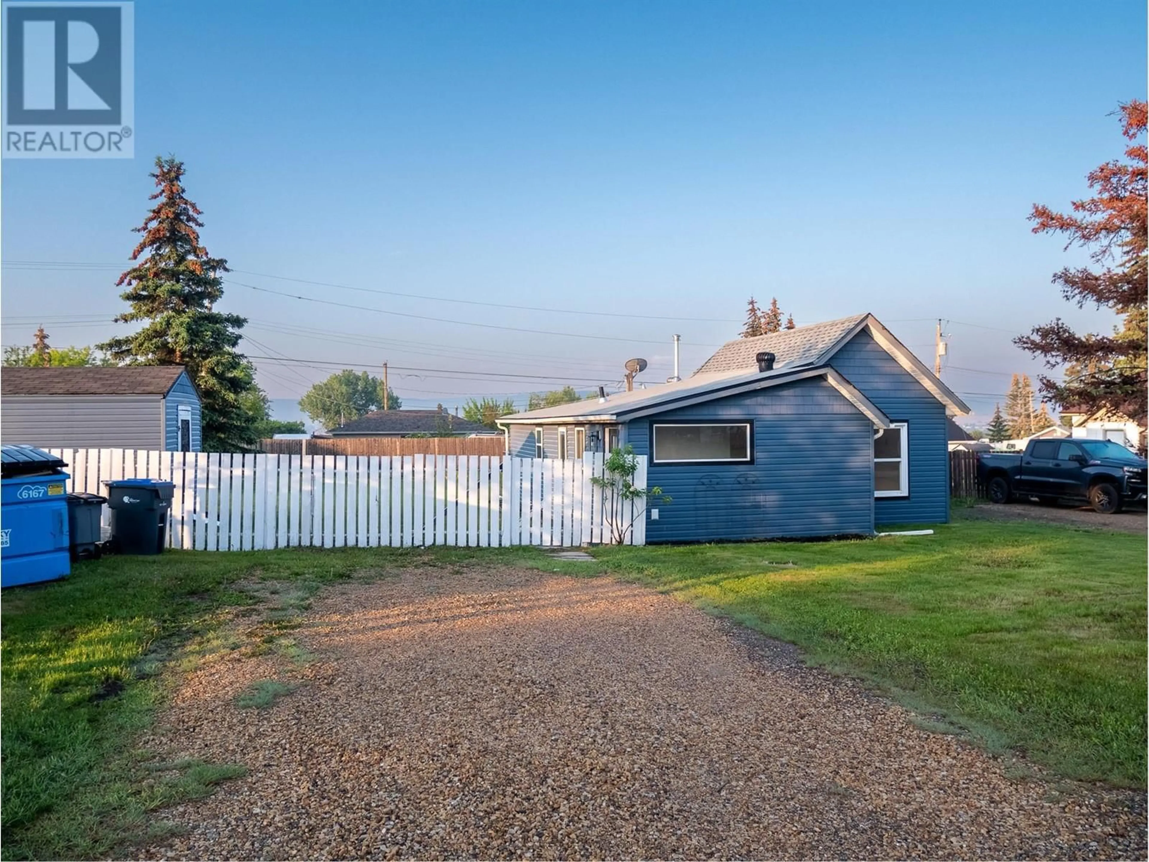 Frontside or backside of a home, the fenced backyard for 1005 95 Avenue, Dawson Creek British Columbia V1G1H9