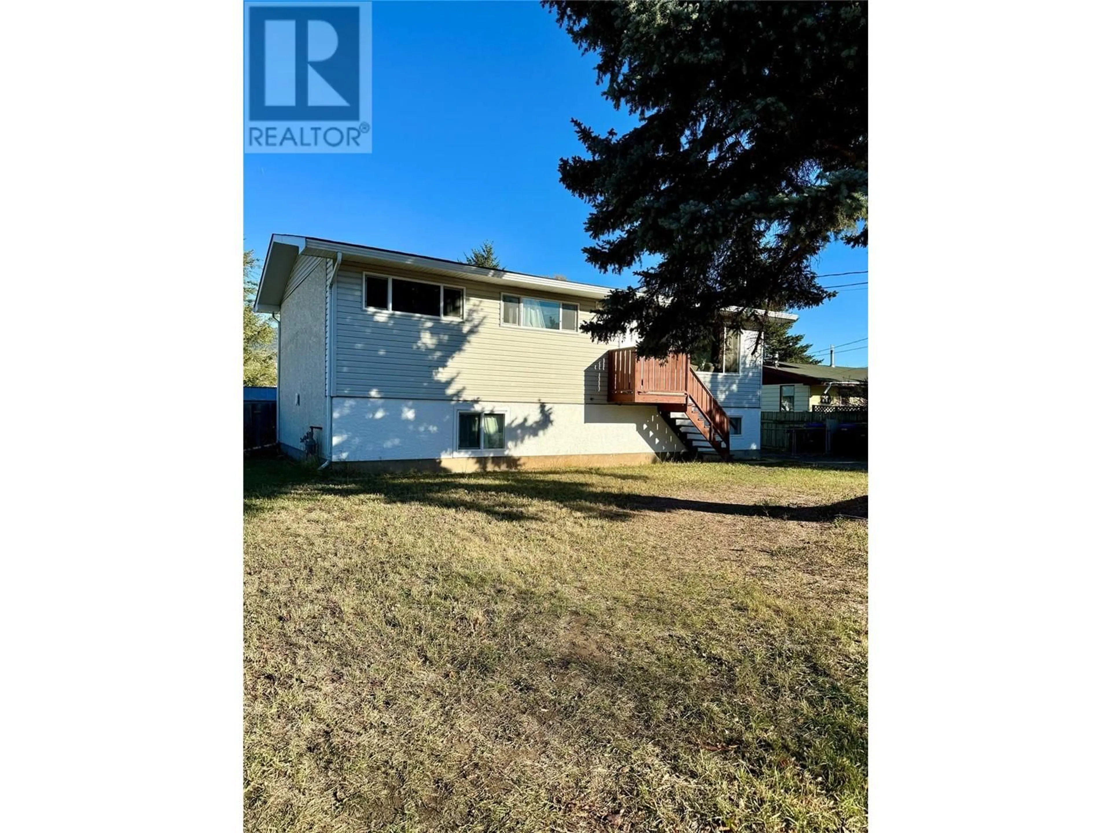 Frontside or backside of a home, the fenced backyard for 2137 PRIEST Avenue, Merritt British Columbia V1K1B8