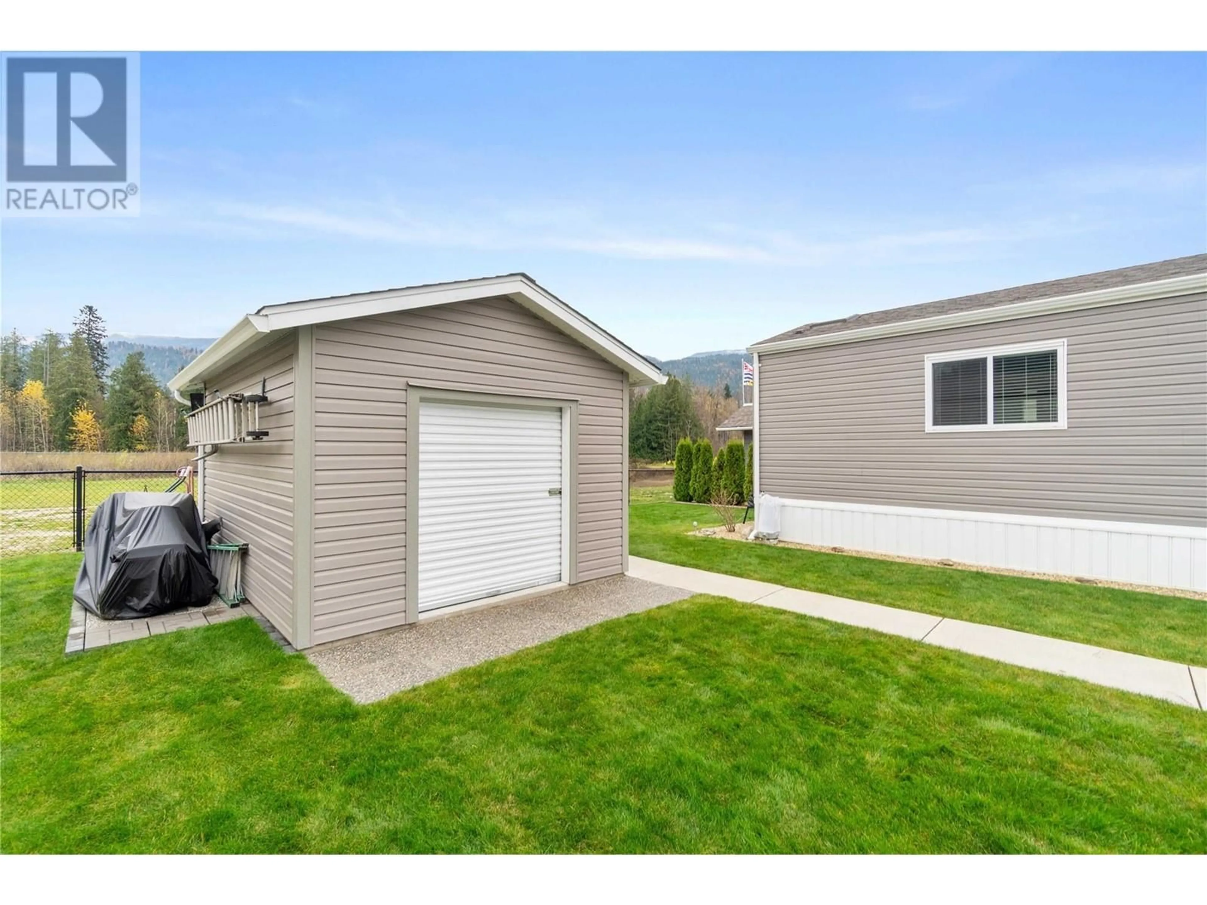 A pic from exterior of the house or condo, the fenced backyard for 1707 Hillier Road E Unit# 3, Sicamous British Columbia V0E2V4