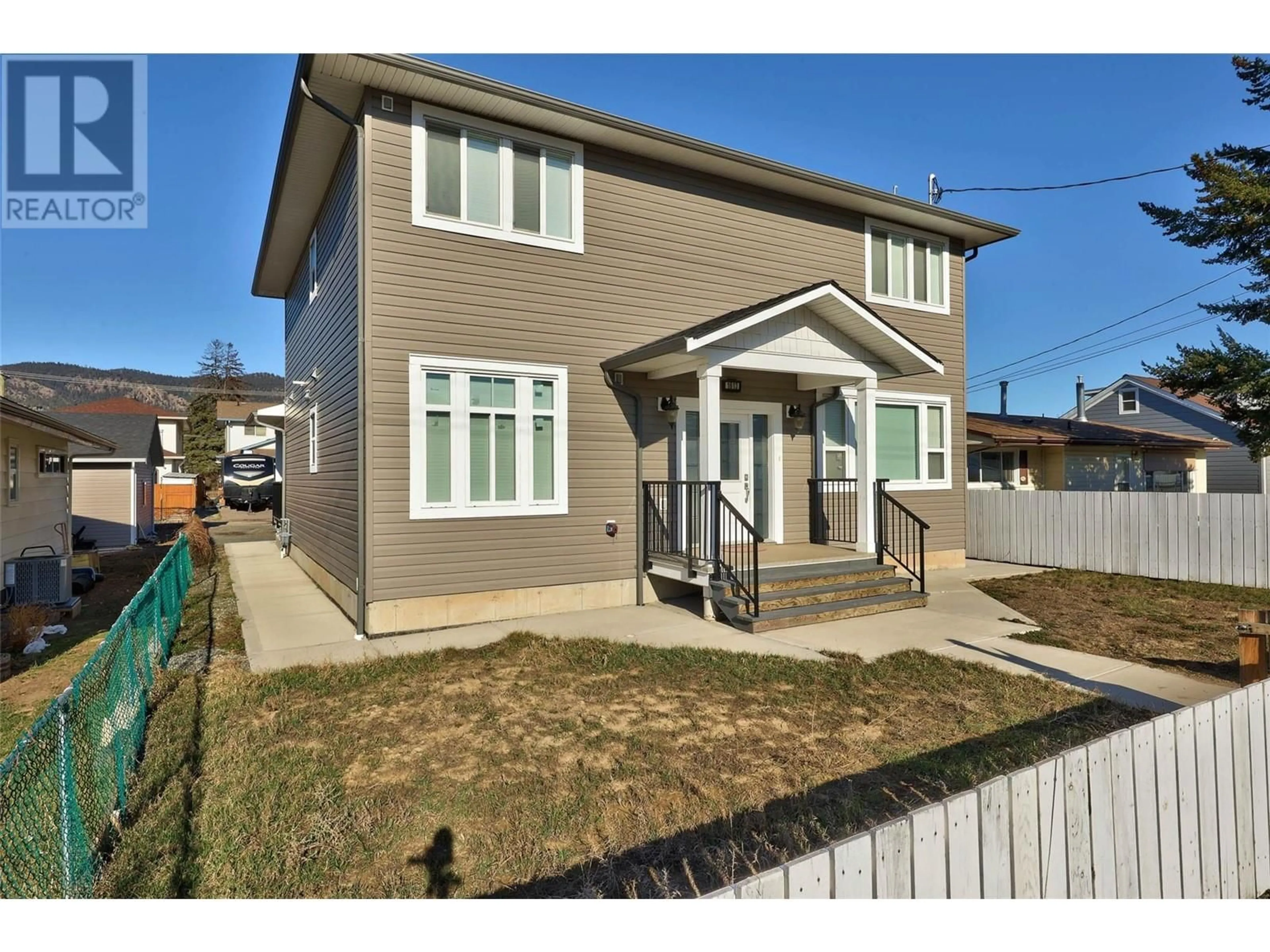 Frontside or backside of a home, the fenced backyard for 1613 Canford Avenue, Merritt British Columbia V1K1R6