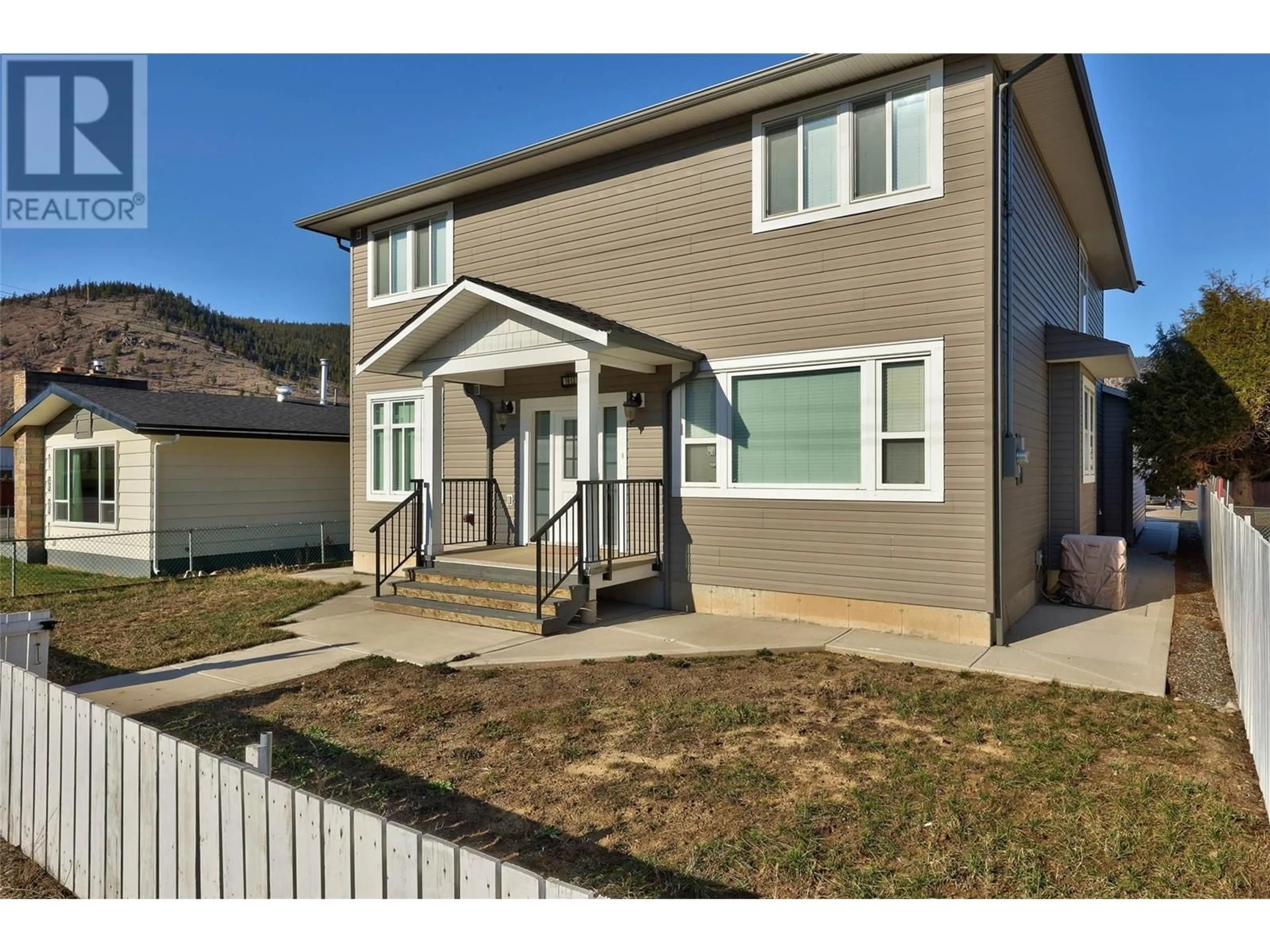 Frontside or backside of a home, the fenced backyard for 1613 Canford Avenue, Merritt British Columbia V1K1R6