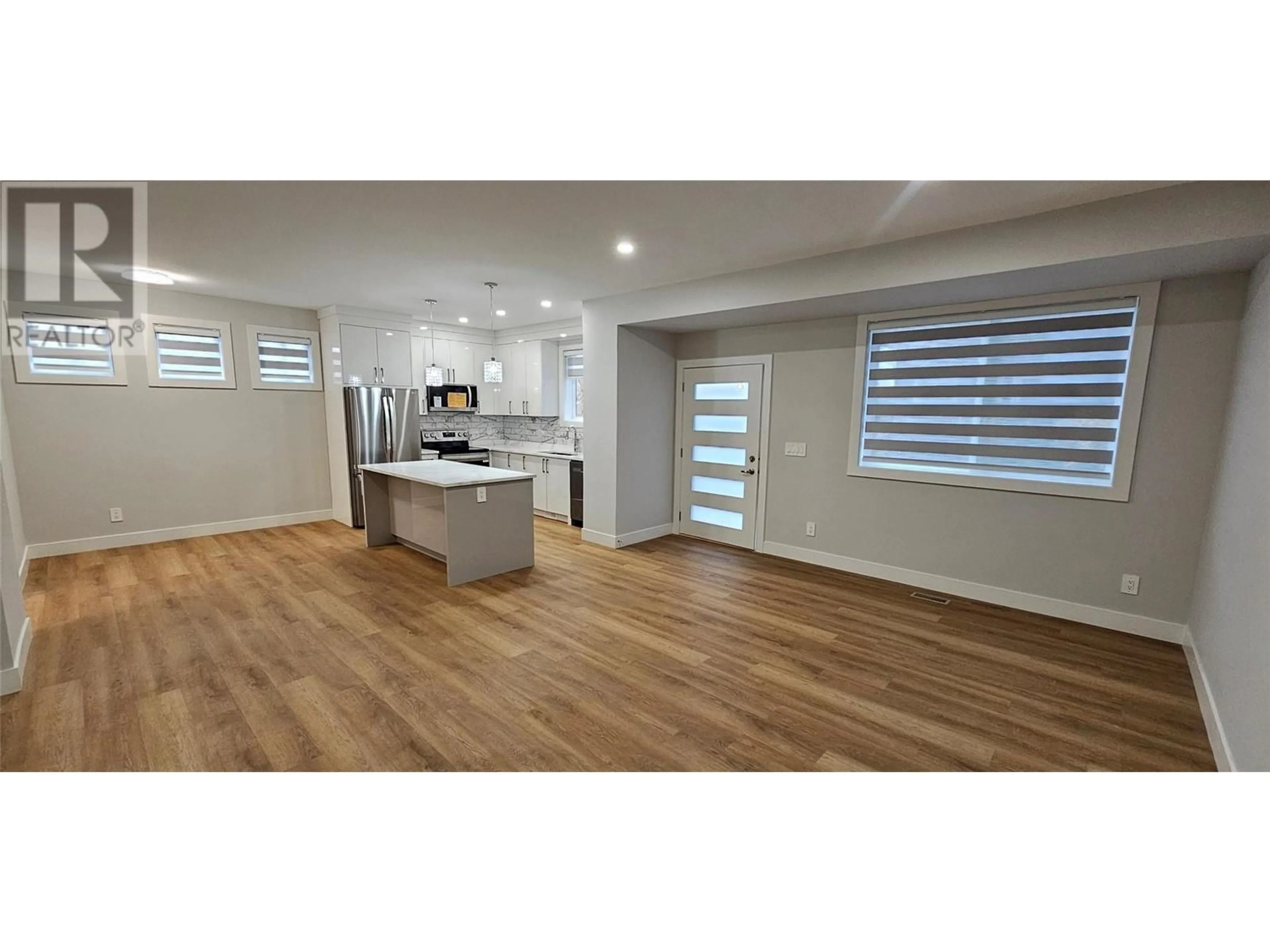 Open concept kitchen, wood/laminate floor for 105 - 125 CALGARY AVENUE, Penticton British Columbia V2A2T7