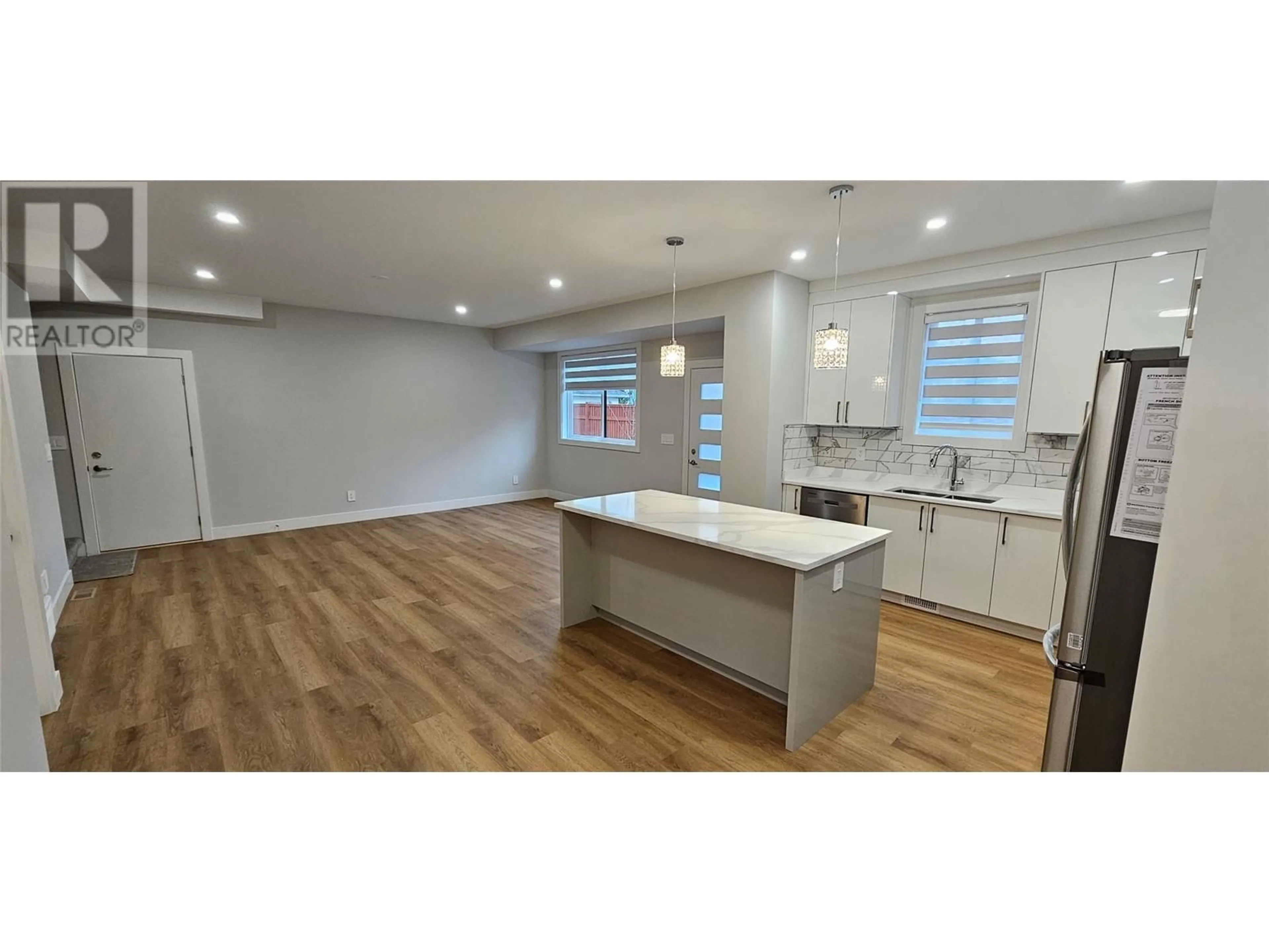 Open concept kitchen, wood/laminate floor for 106 - 125 CALGARY AVENUE, Penticton British Columbia V2A2T7