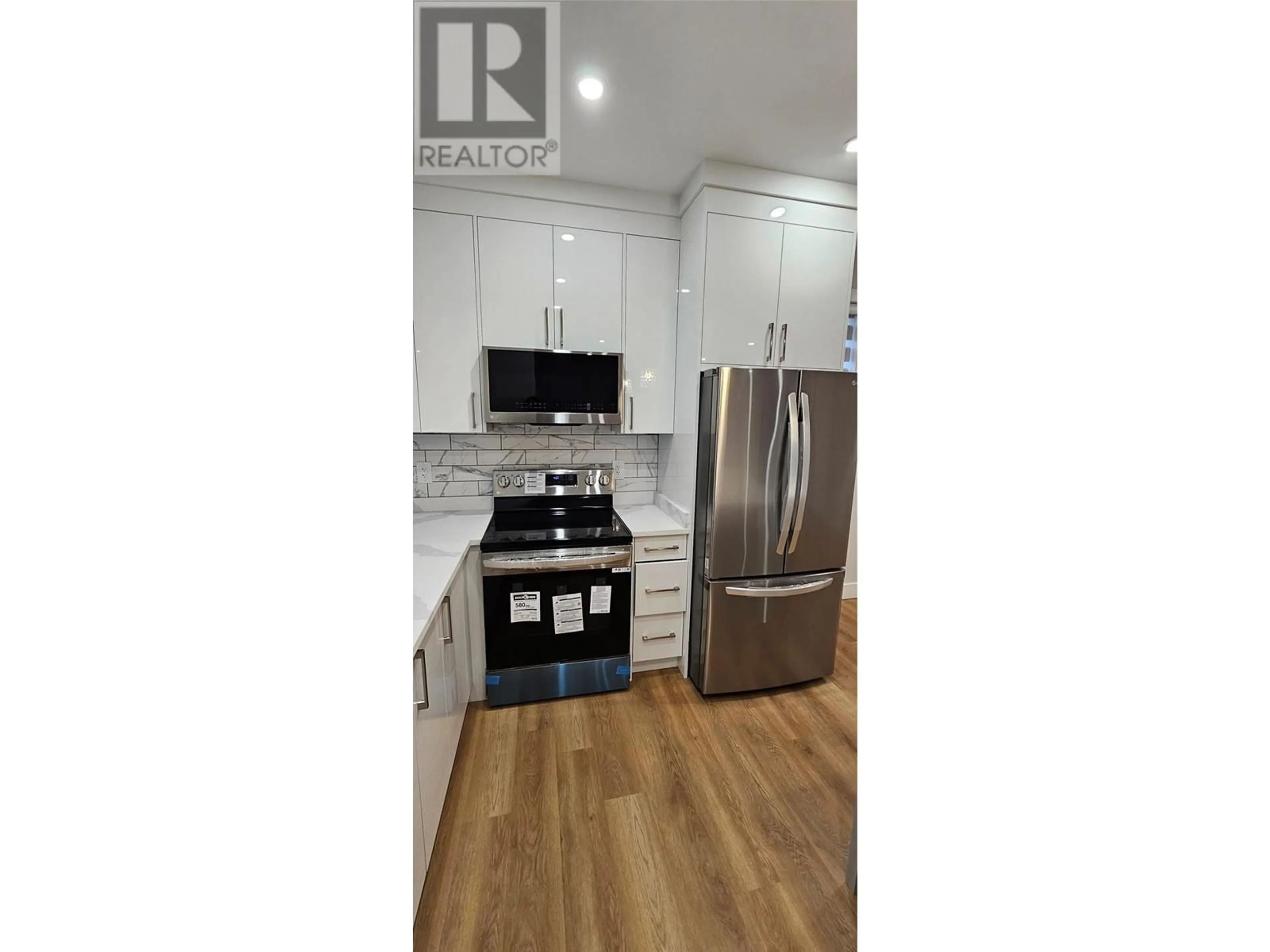 Open concept kitchen, wood/laminate floor for 106 - 125 CALGARY AVENUE, Penticton British Columbia V2A2T7