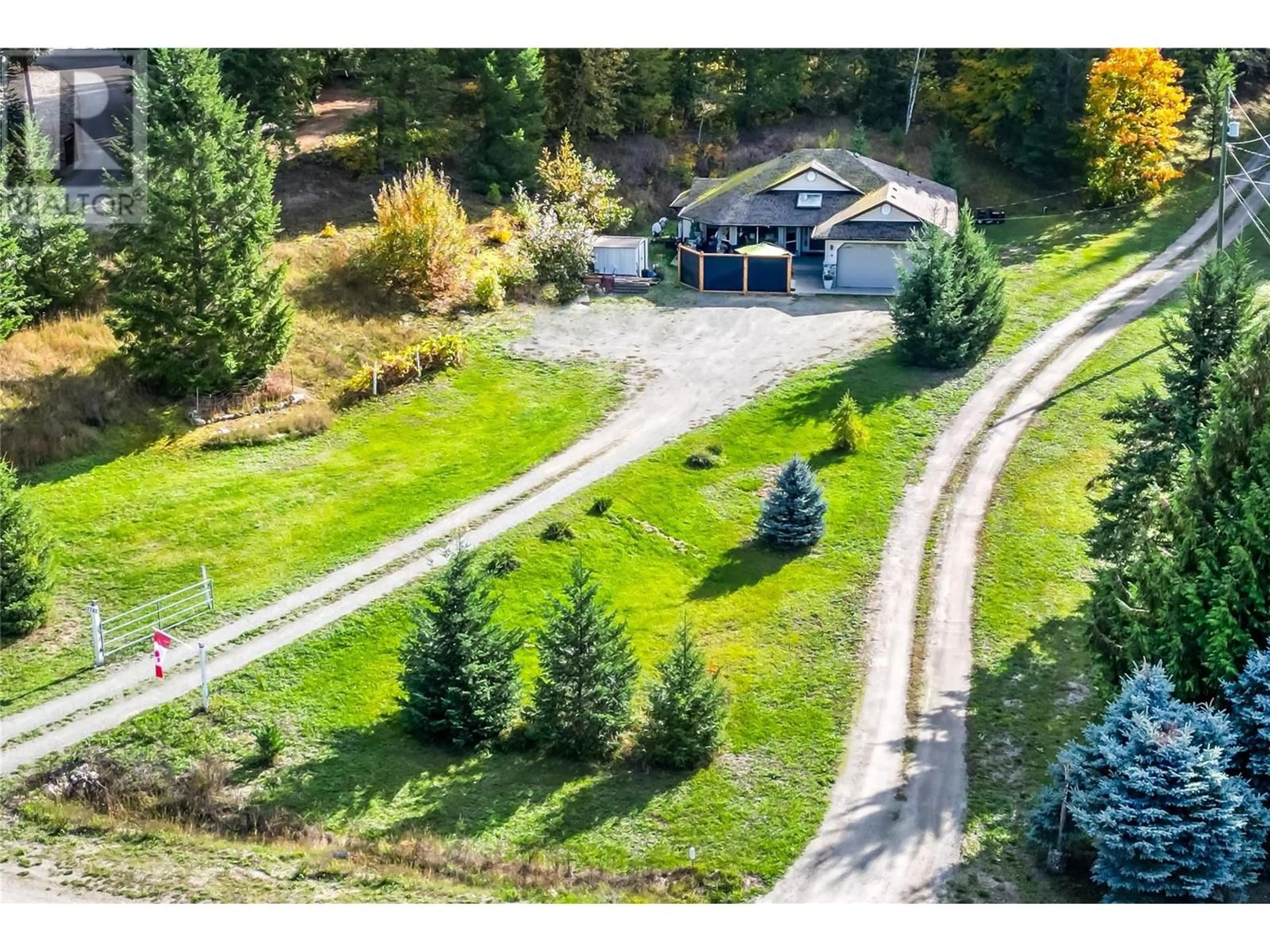 Frontside or backside of a home, the fenced backyard for 7781 97A Highway, Mara British Columbia V0E2K0