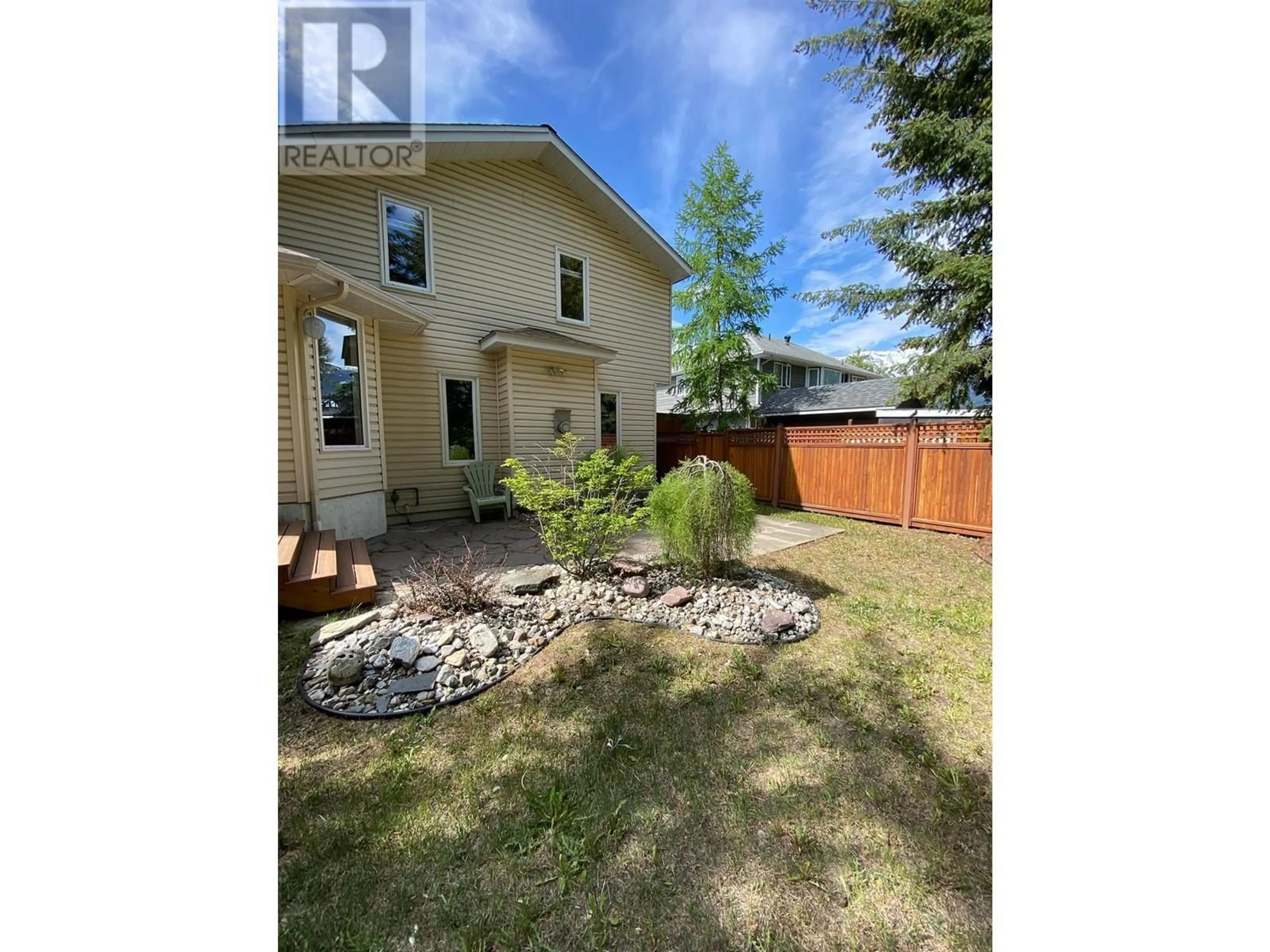 Frontside or backside of a home, the fenced backyard for 1517 Fir Crescent, Golden British Columbia V0A1H6