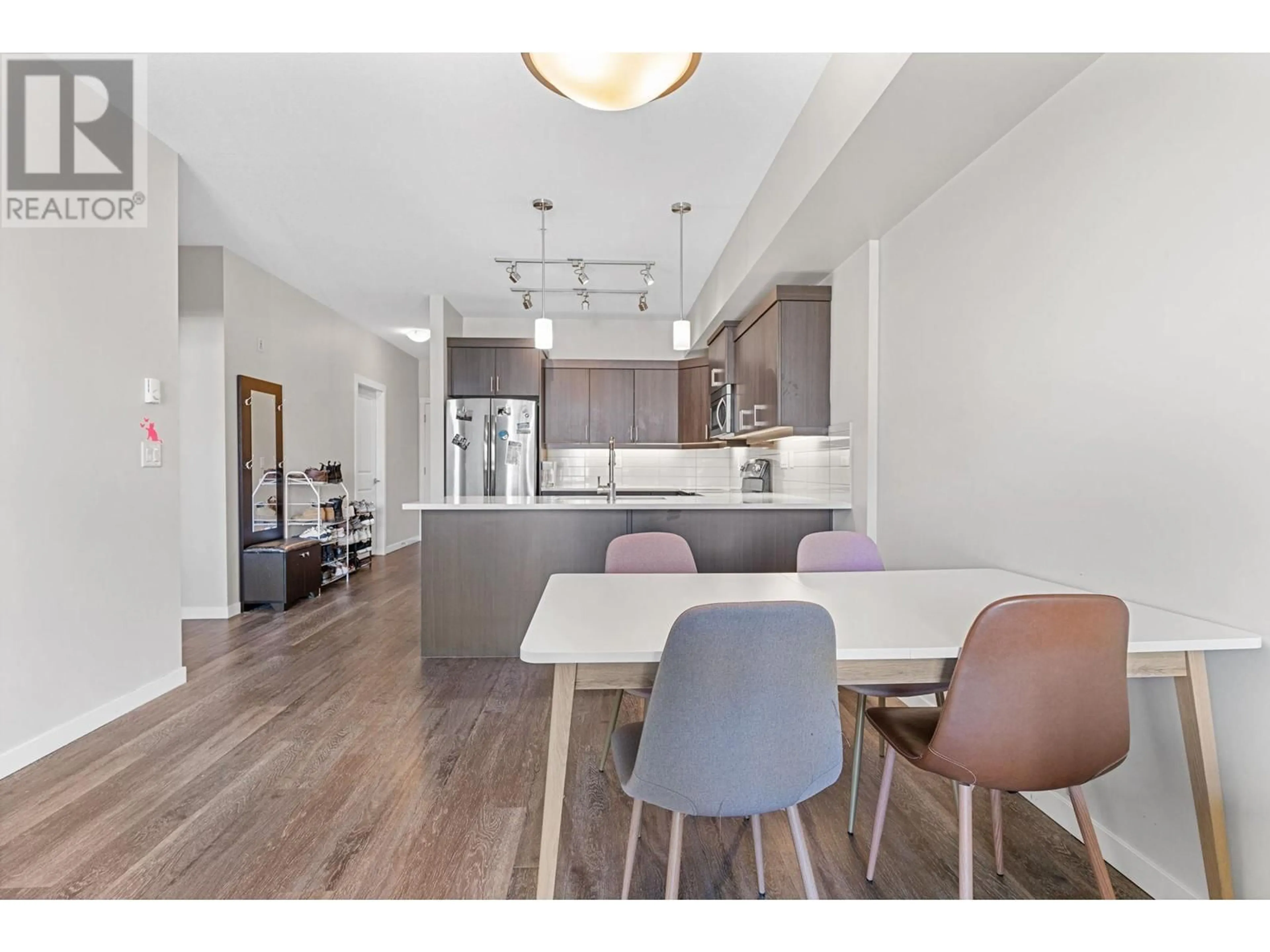 Open concept kitchen, wood/laminate floor for 210 - 3731 CASORSO ROAD, Kelowna British Columbia V1W5E9
