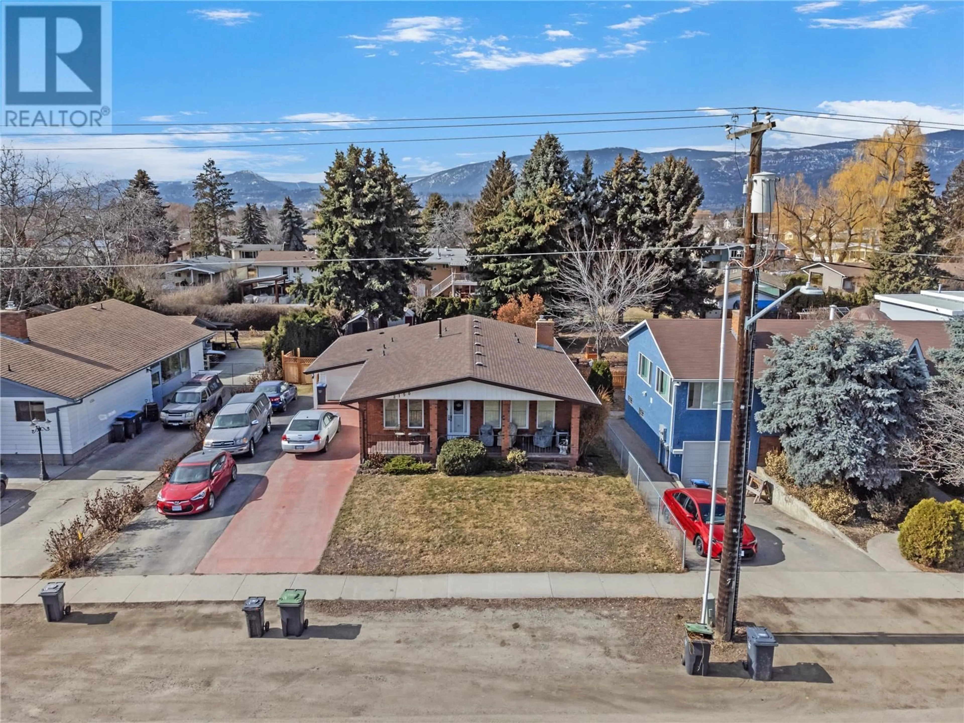 A pic from outside/outdoor area/front of a property/back of a property/a pic from drone, mountain view for 2150 BURTCH ROAD, Kelowna British Columbia V1Y4B5