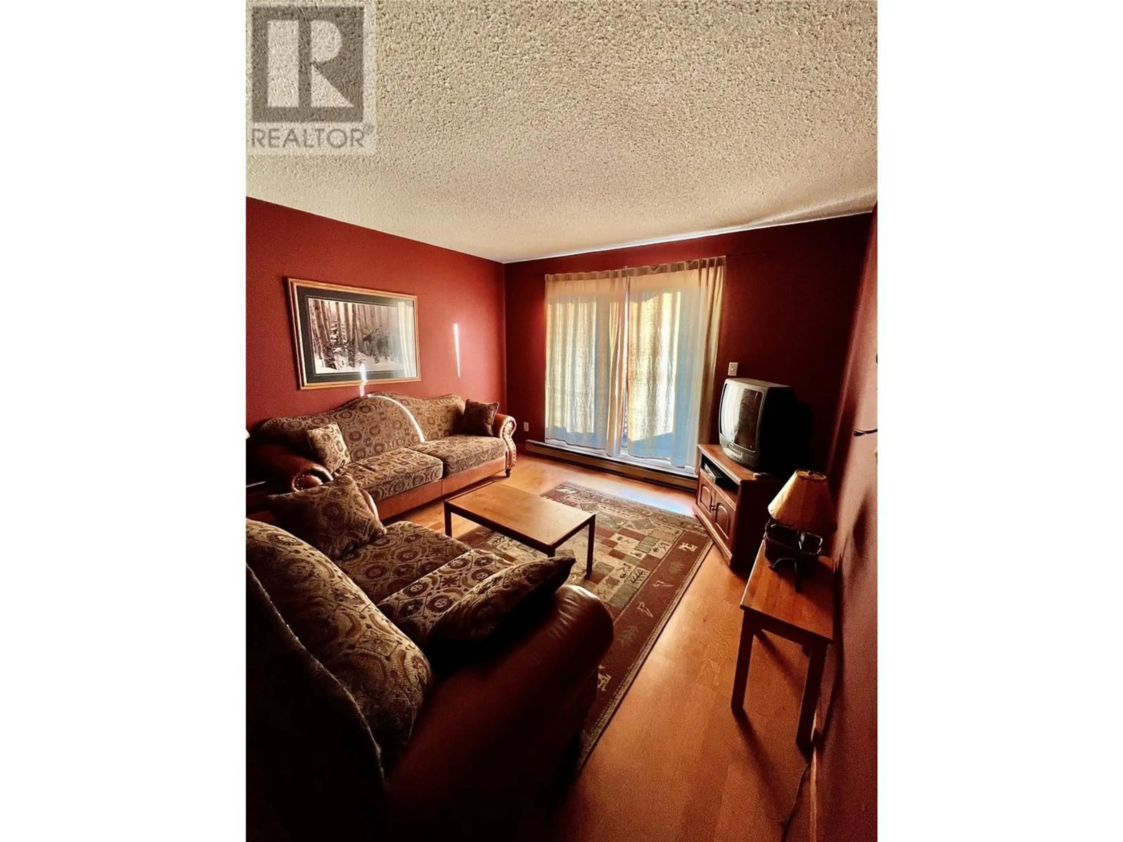 Living room with furniture, wood/laminate floor for 206 - 195 CHAMBERLAIN CRESCENT, Tumbler Ridge British Columbia V0C2W0