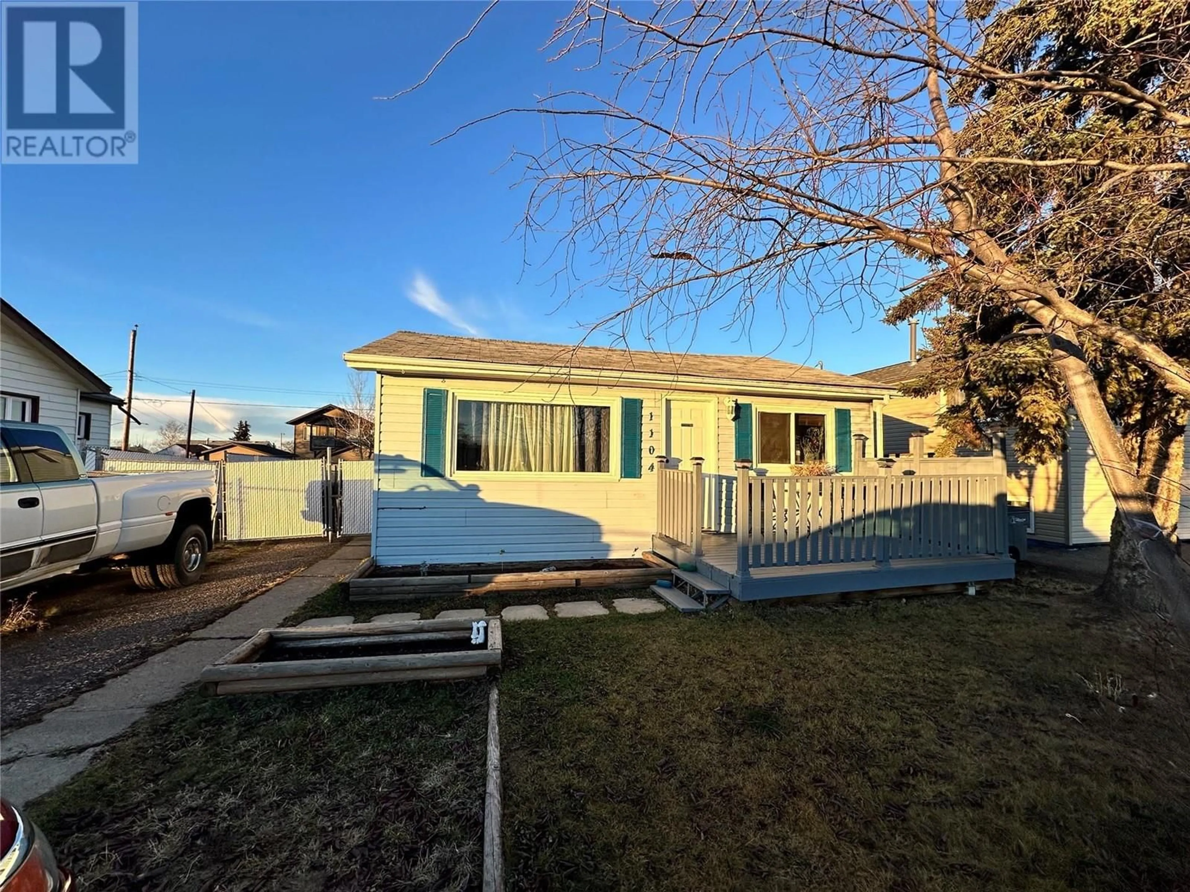 A pic from exterior of the house or condo, the fenced backyard for 1104 120 Avenue, Dawson Creek British Columbia V1G3K1