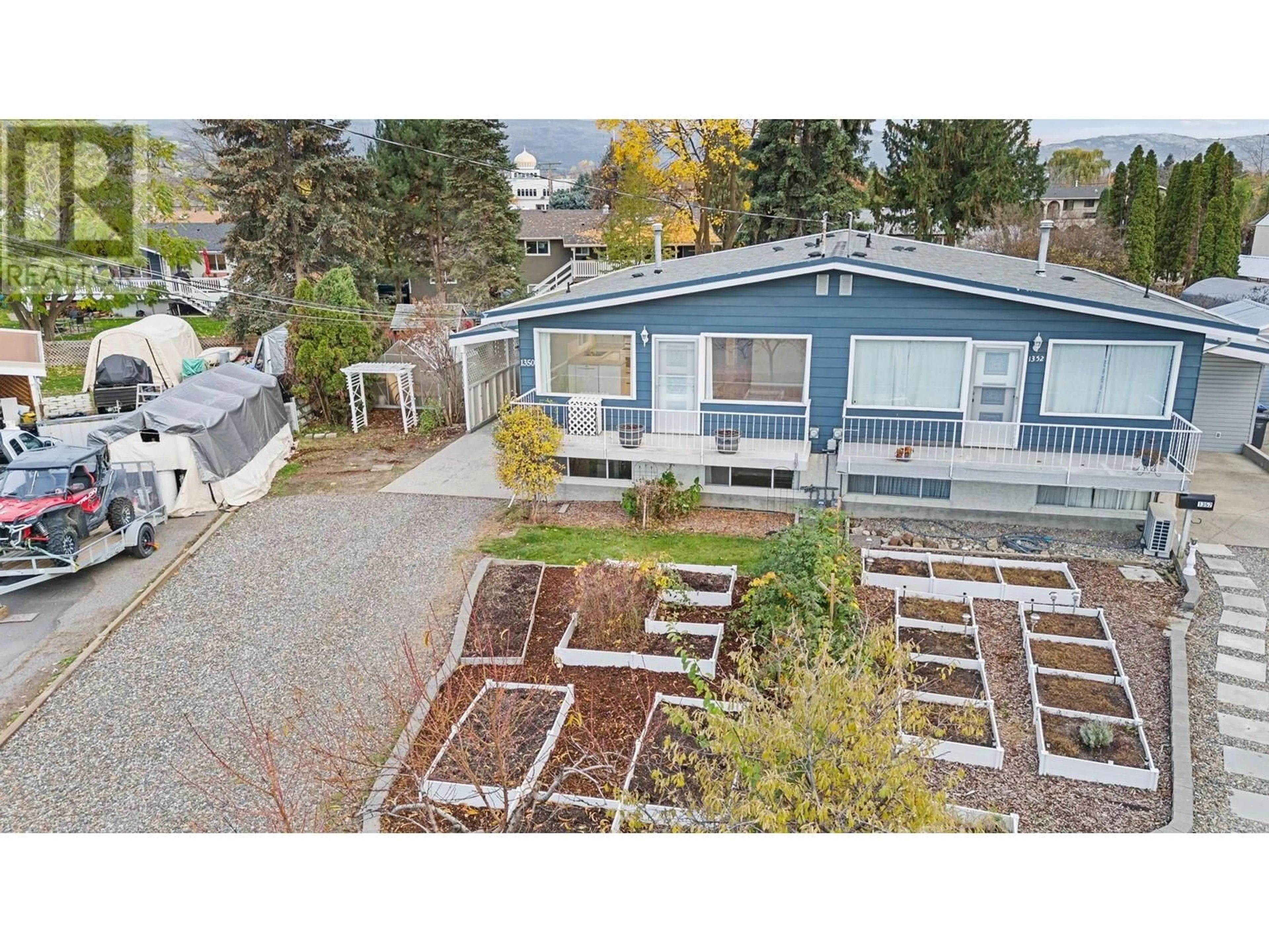 A pic from exterior of the house or condo, the fenced backyard for 1350 Maple Road, Kelowna British Columbia V1X4Y4