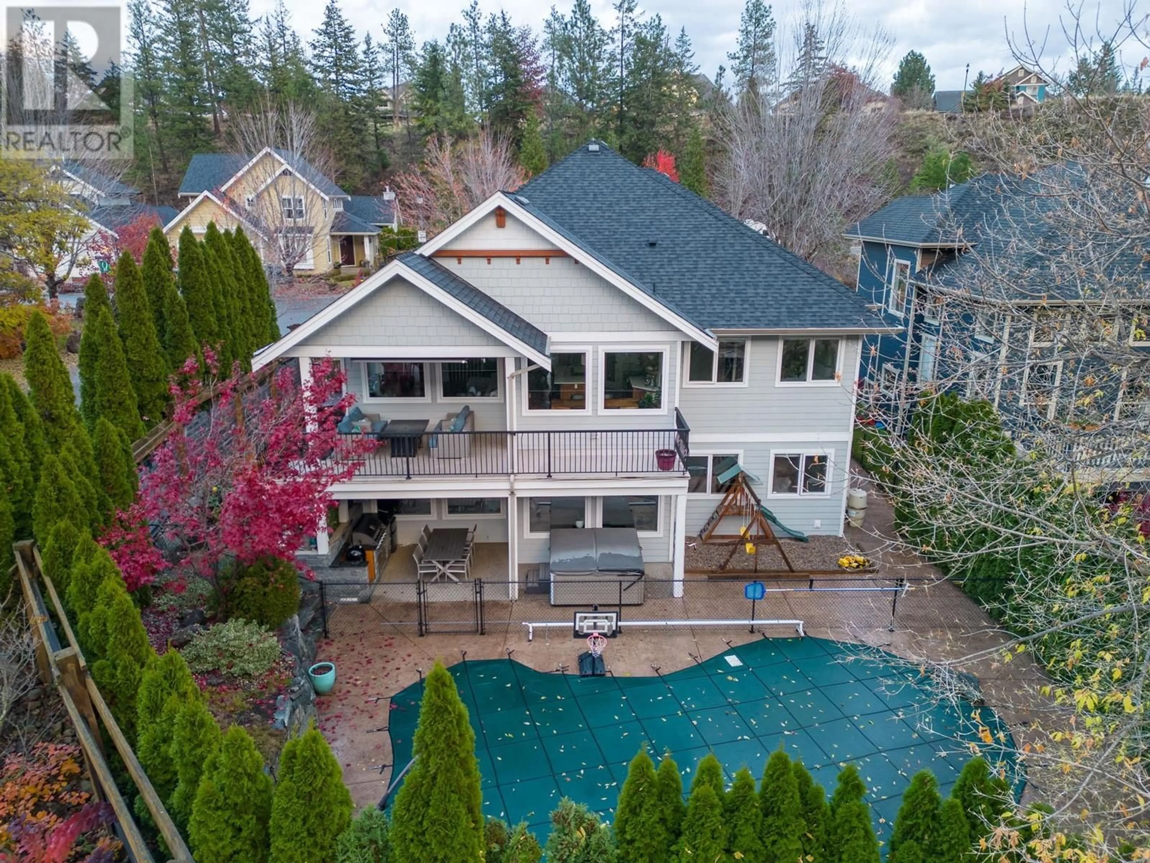 Frontside or backside of a home, the fenced backyard for 404 Still Pond Place, Kelowna British Columbia V1V2R8