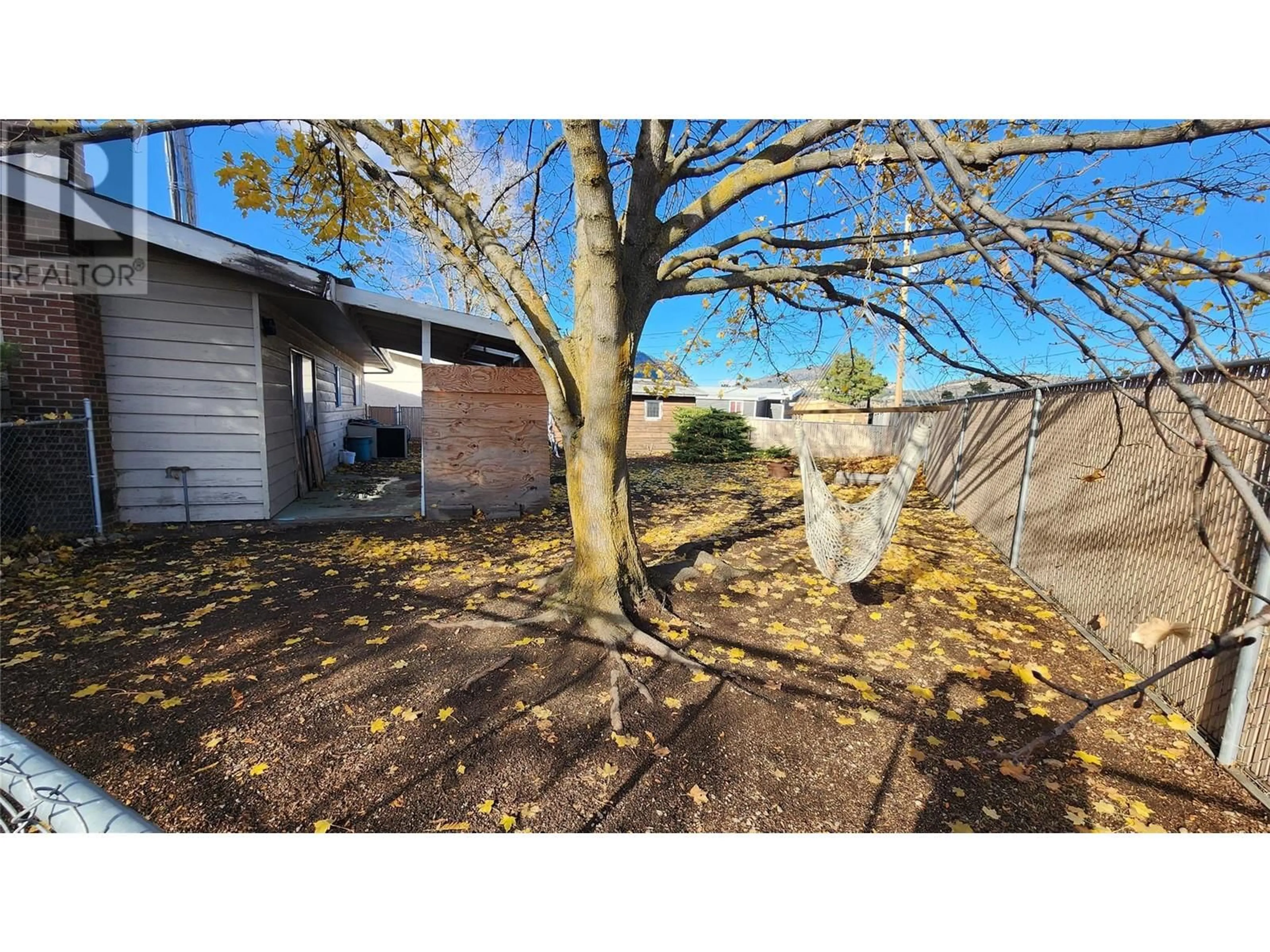 Frontside or backside of a home, the fenced backyard for 7519 Crest-A-Way Road, Oliver British Columbia V0H1T2