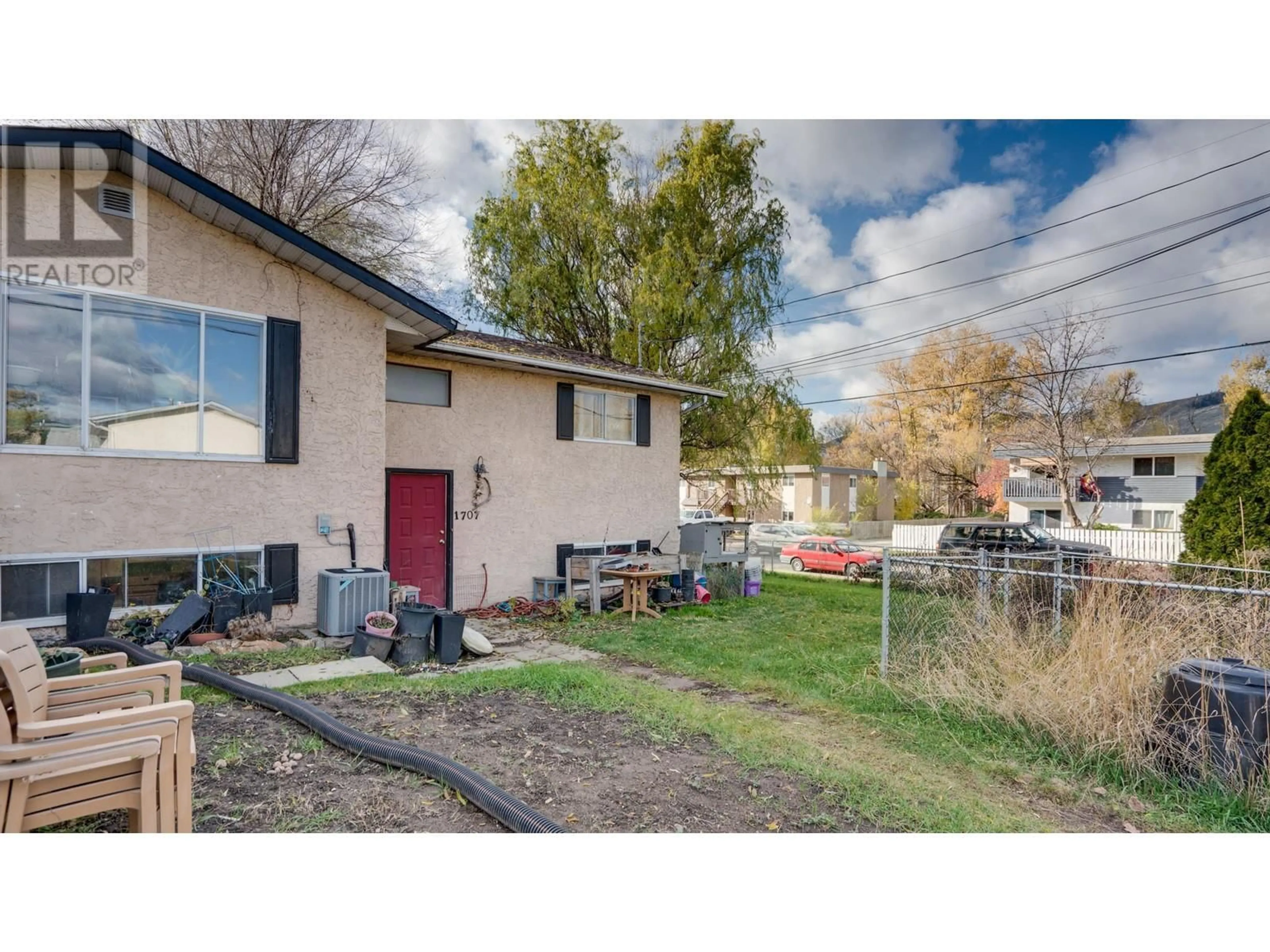 Frontside or backside of a home, the fenced backyard for 1707 45 Street, Vernon British Columbia V1T7P9