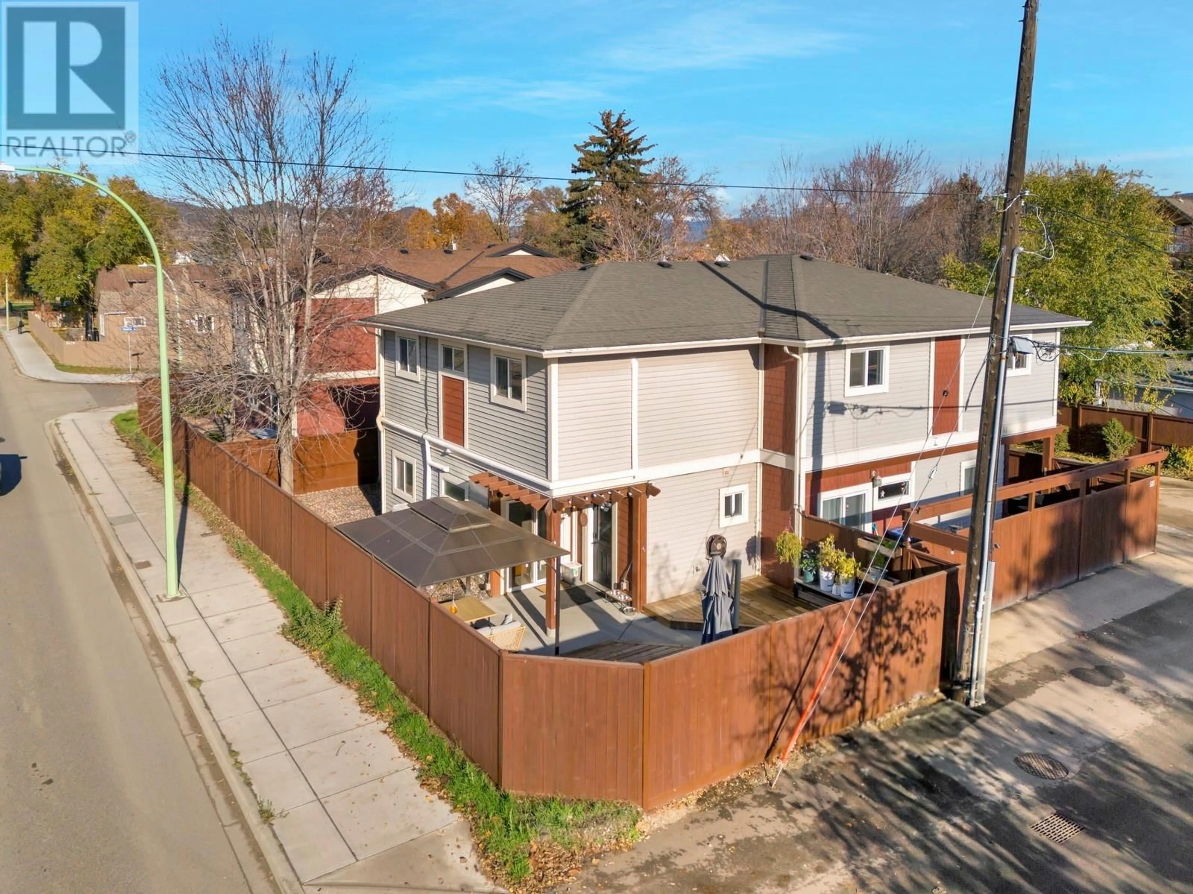 Frontside or backside of a home, the fenced backyard for 515 Francis Avenue Unit# 2, Kelowna British Columbia V1Y5G4