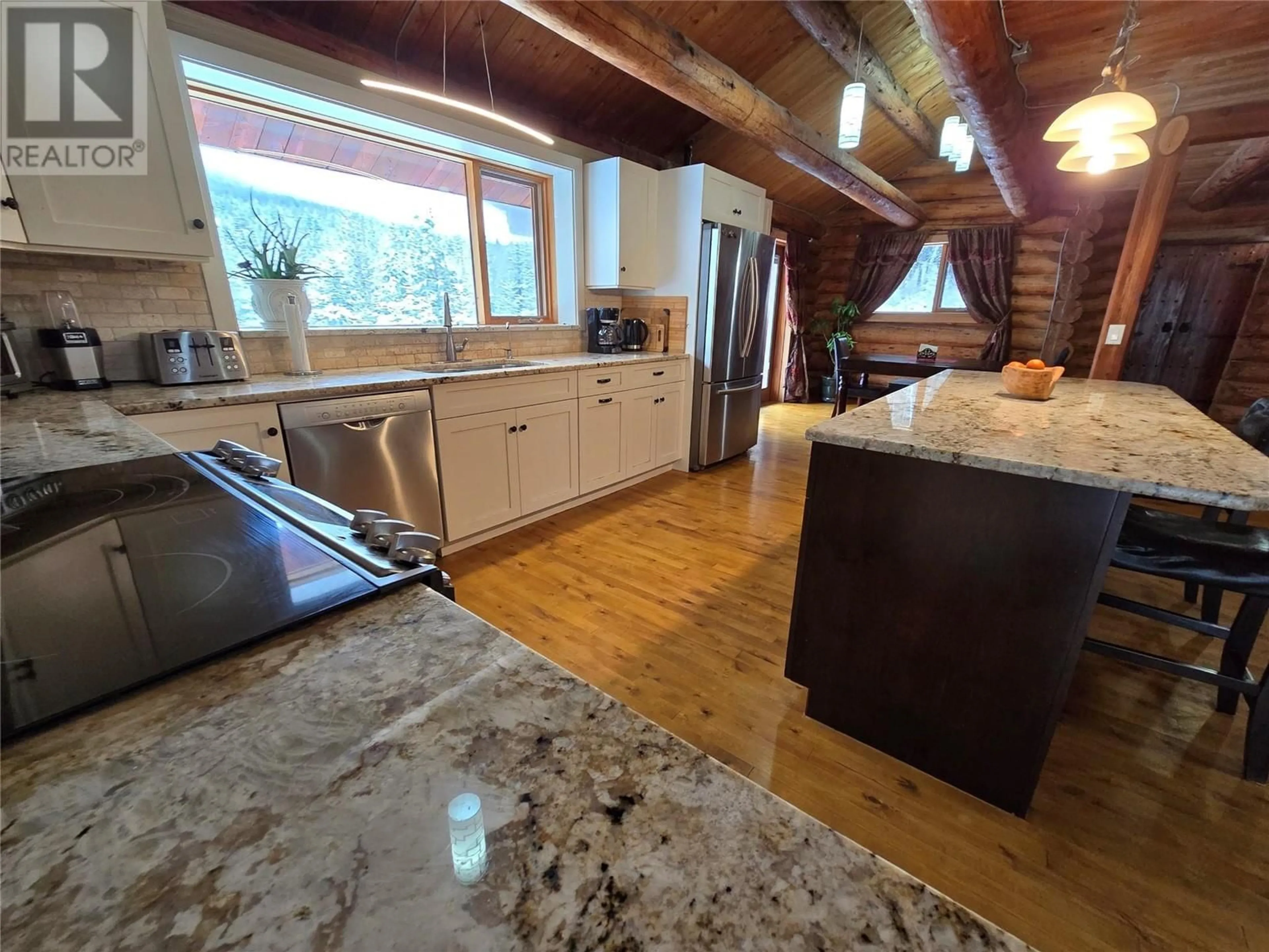 Open concept kitchen, wood/laminate floor for 2358 DUNN LAKE ROAD, Clearwater British Columbia V0E1N0