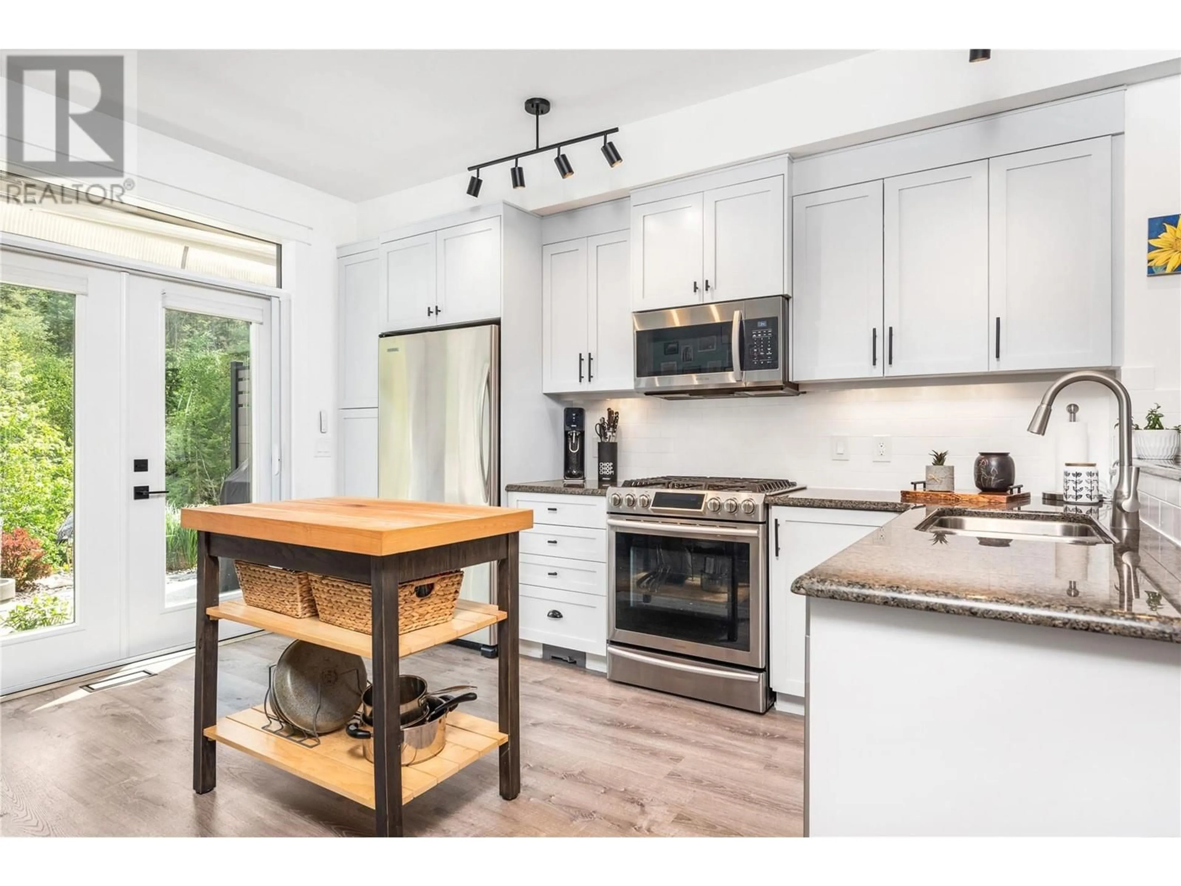 Open concept kitchen, wood/laminate floor for 37 - 333 LONGSPOON DRIVE, Vernon British Columbia V1H2L1