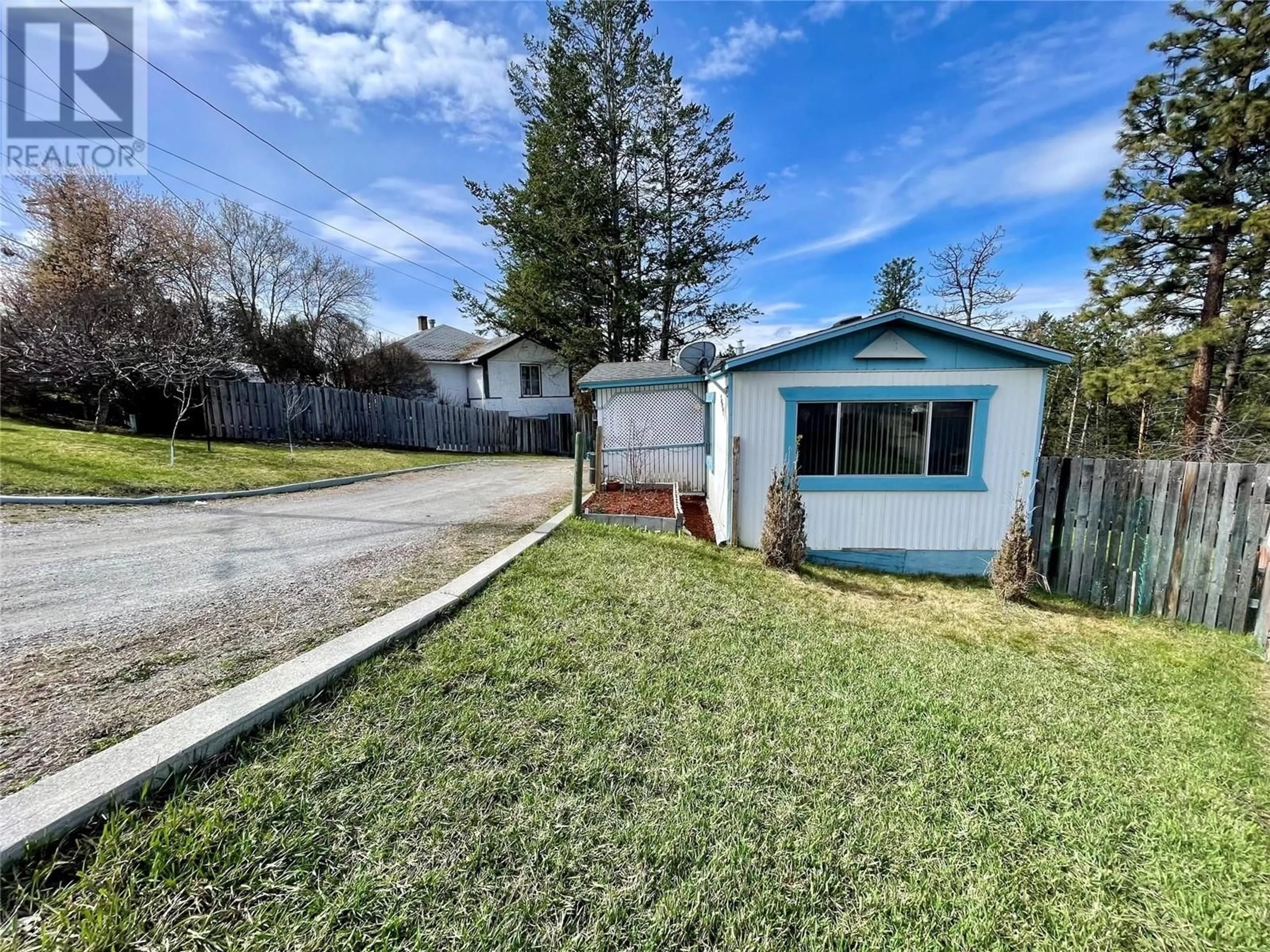 Frontside or backside of a home, the fenced backyard for 2321 33RD Avenue N, Cranbrook British Columbia V1C3Y9