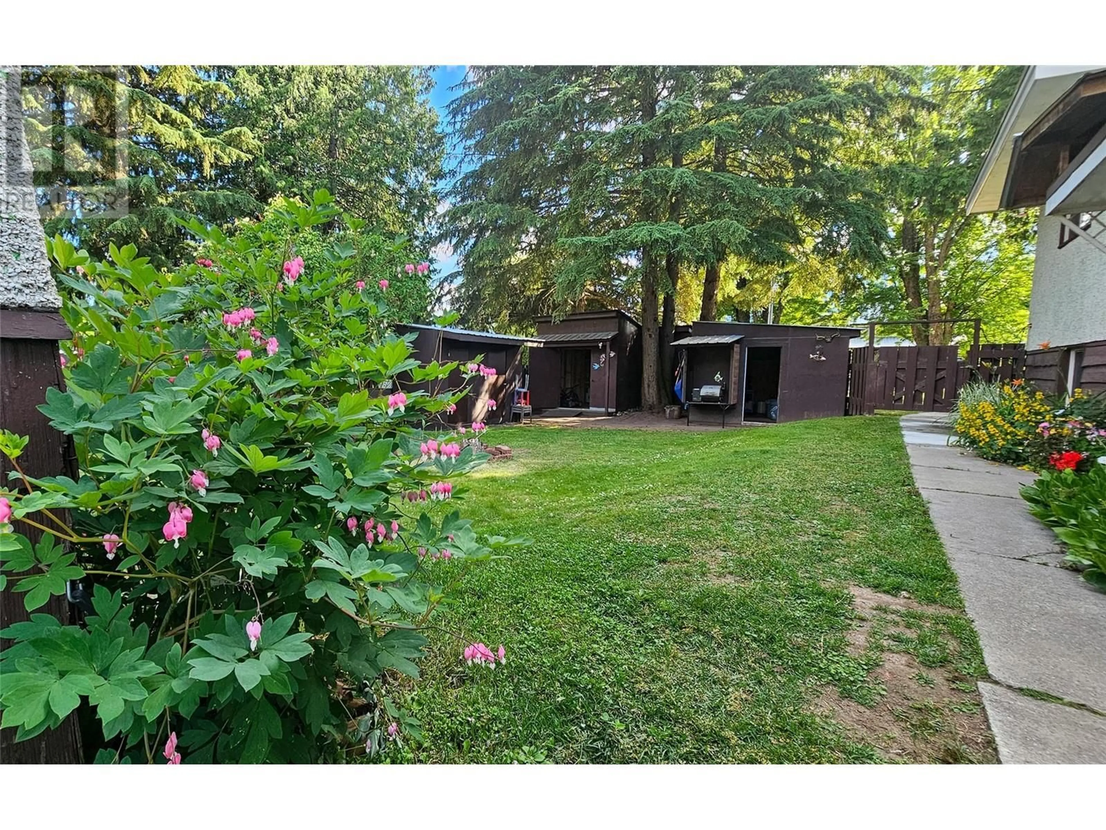 A pic from exterior of the house or condo, the fenced backyard for 1120 First Street W, Revelstoke British Columbia V0E2S0