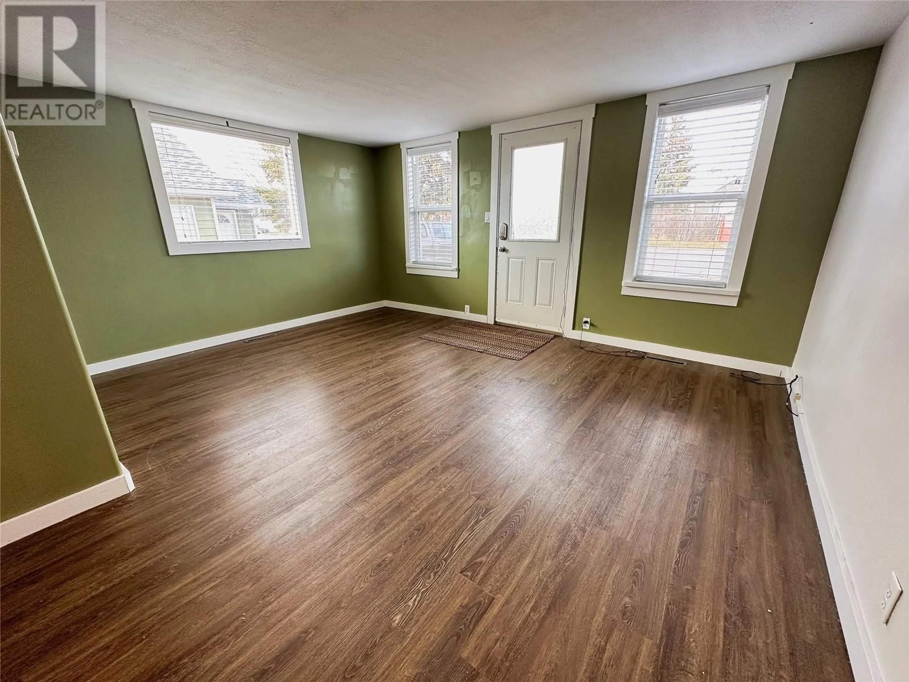 A pic of a room, wood floors for 1117 105 Avenue, Dawson Creek British Columbia V1G2L6