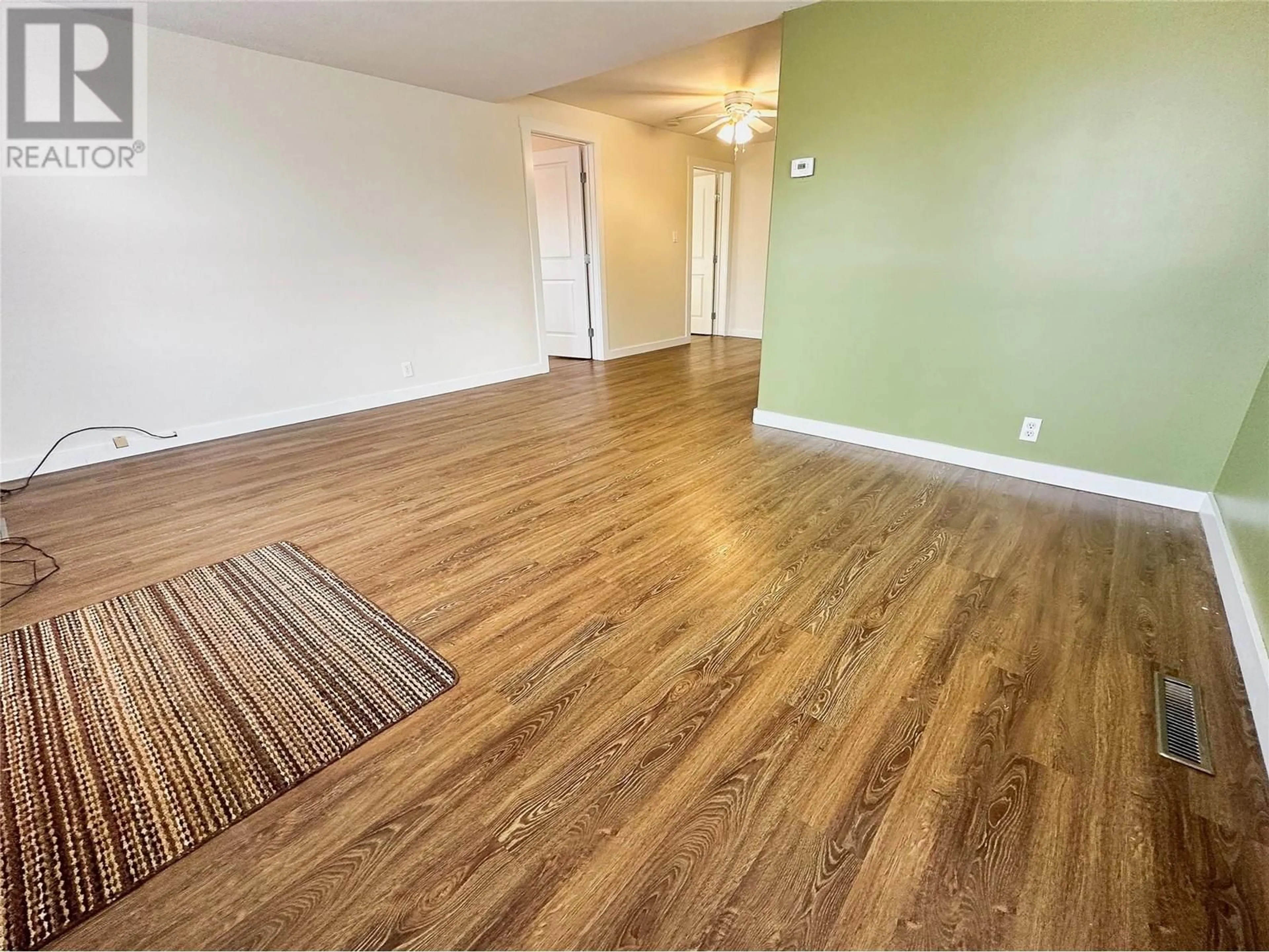 A pic of a room, wood floors for 1117 105 Avenue, Dawson Creek British Columbia V1G2L6