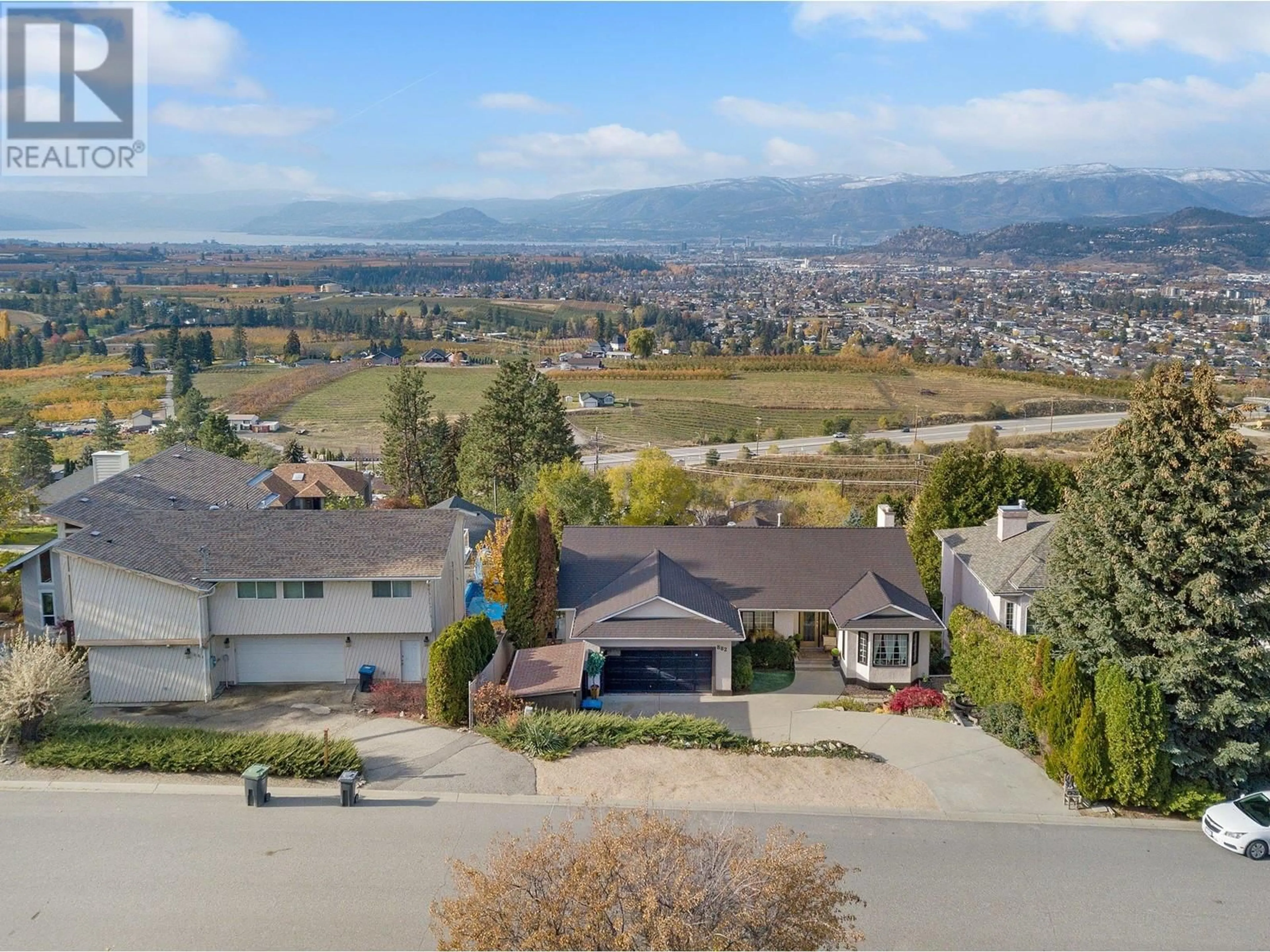 Frontside or backside of a home, the street view for 882 Toovey Road, Kelowna British Columbia V1X6R1