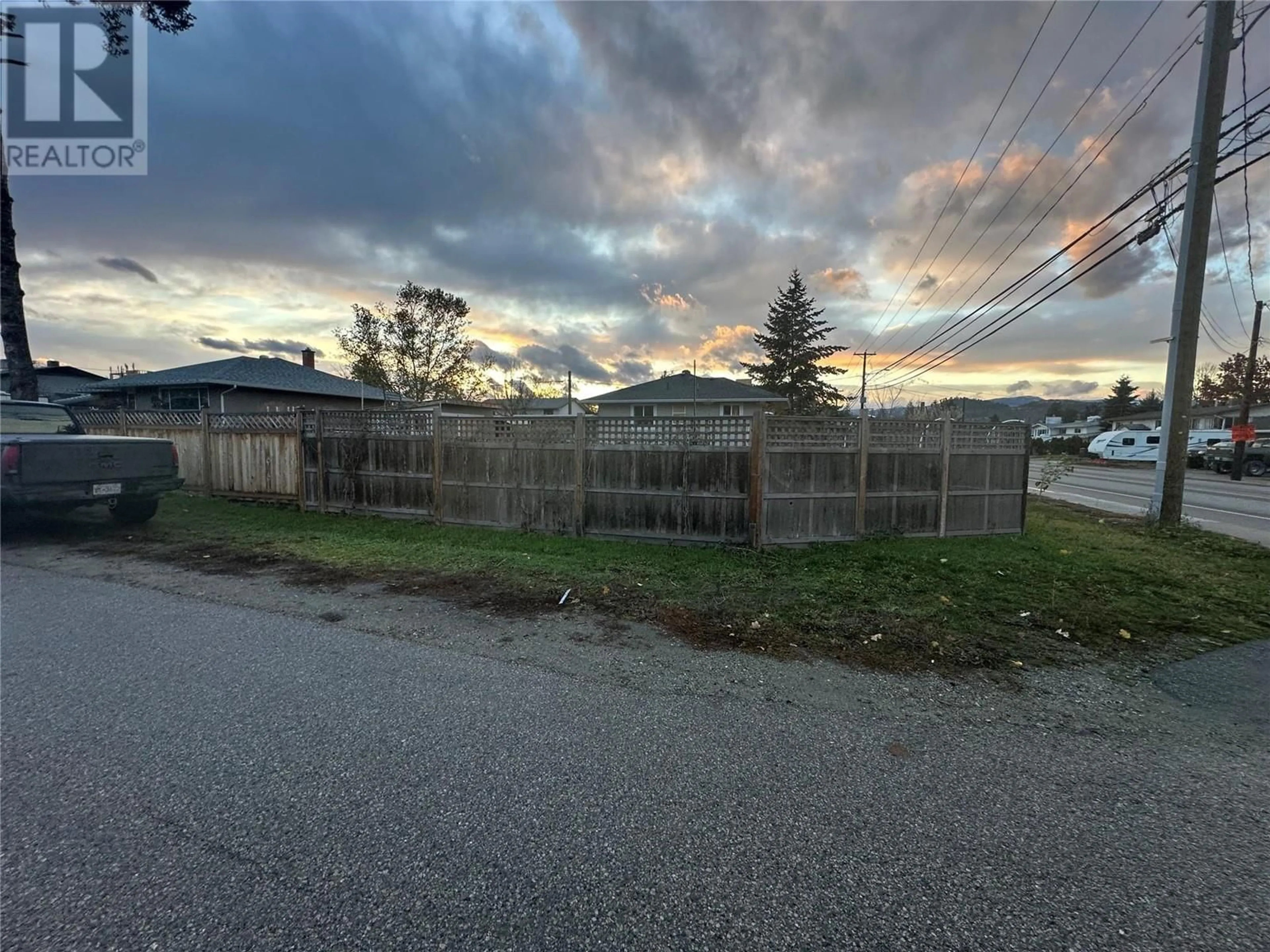 Frontside or backside of a home, the fenced backyard for 295 Leathead Road, Kelowna British Columbia V1X2J1