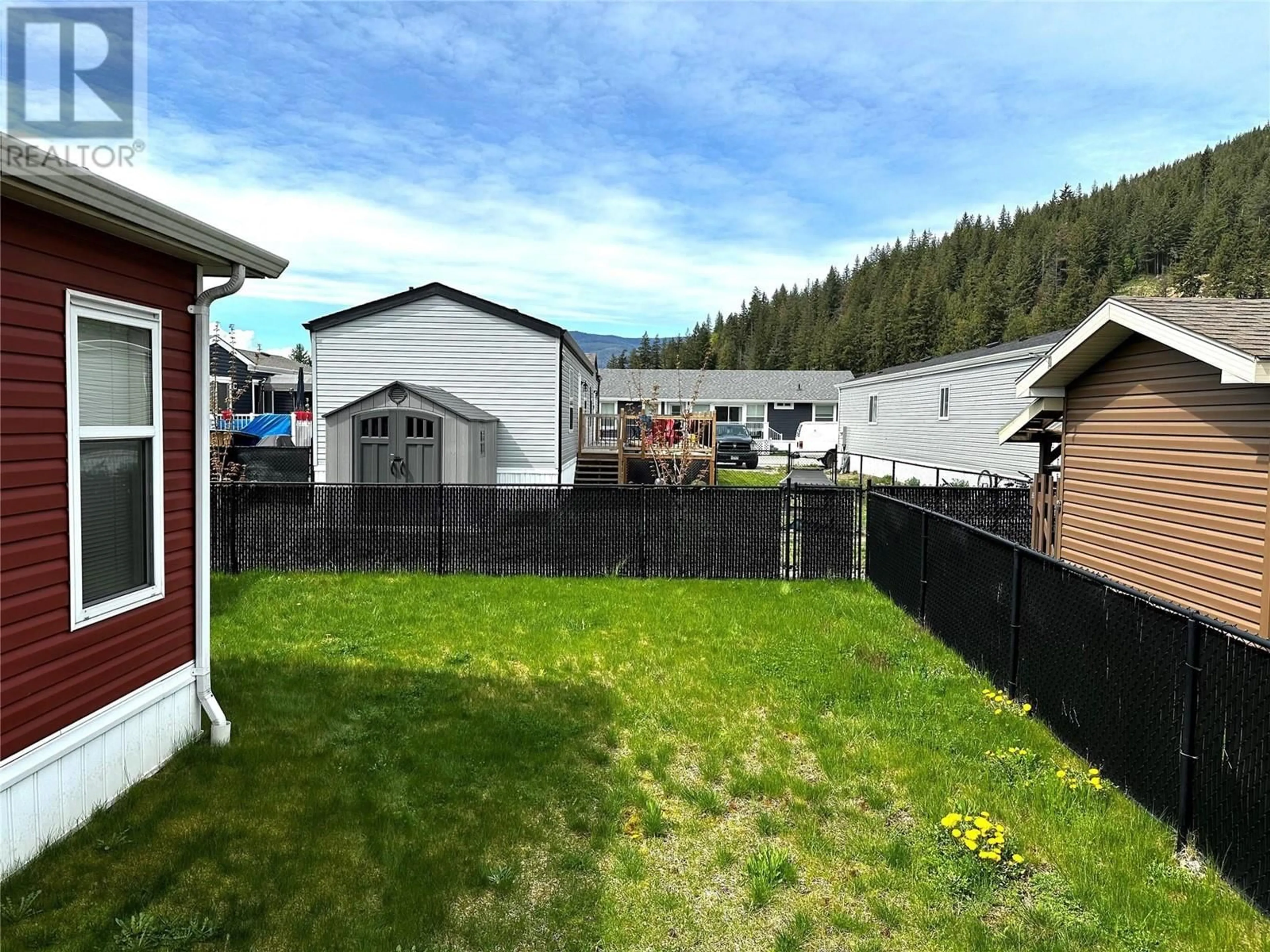 Frontside or backside of a home, the fenced backyard for 1707 Hillier Road Unit# 14, Sicamous British Columbia V0E2V4