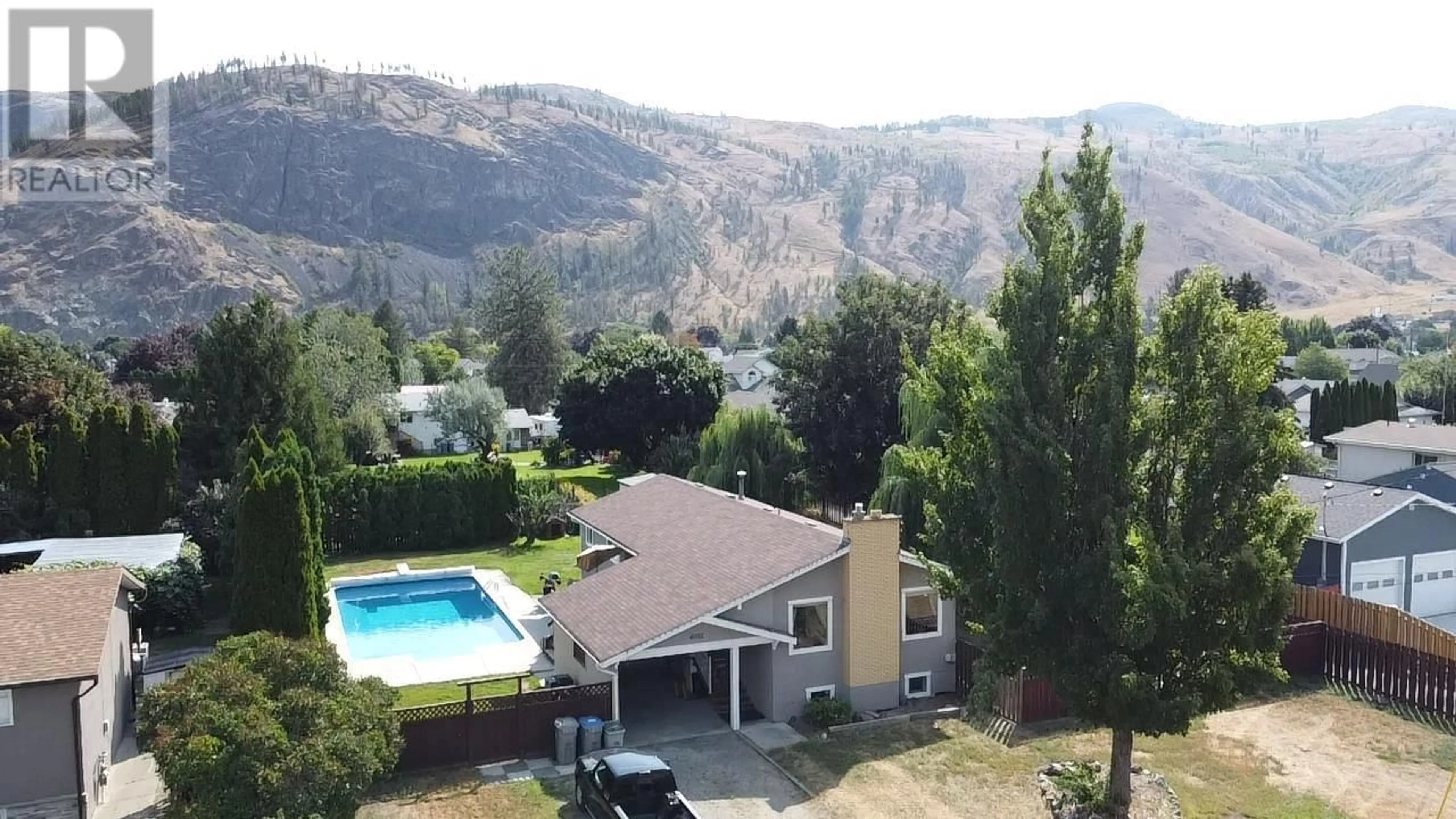 A pic from exterior of the house or condo, the fenced backyard for 4702 SPURRAWAY Road, Kamloops British Columbia V2H1M7