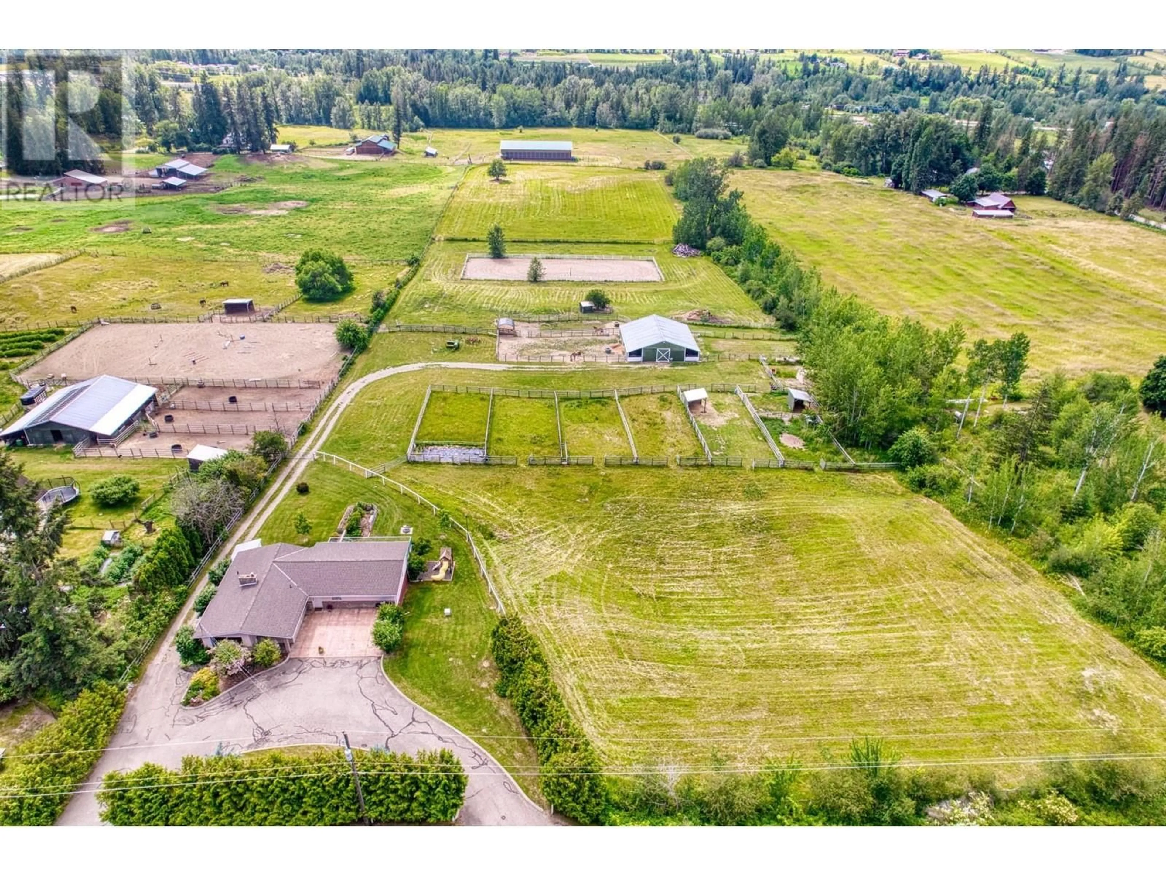 Frontside or backside of a home, the fenced backyard for 1631 60 Street NE, Salmon Arm British Columbia V1E1Y3