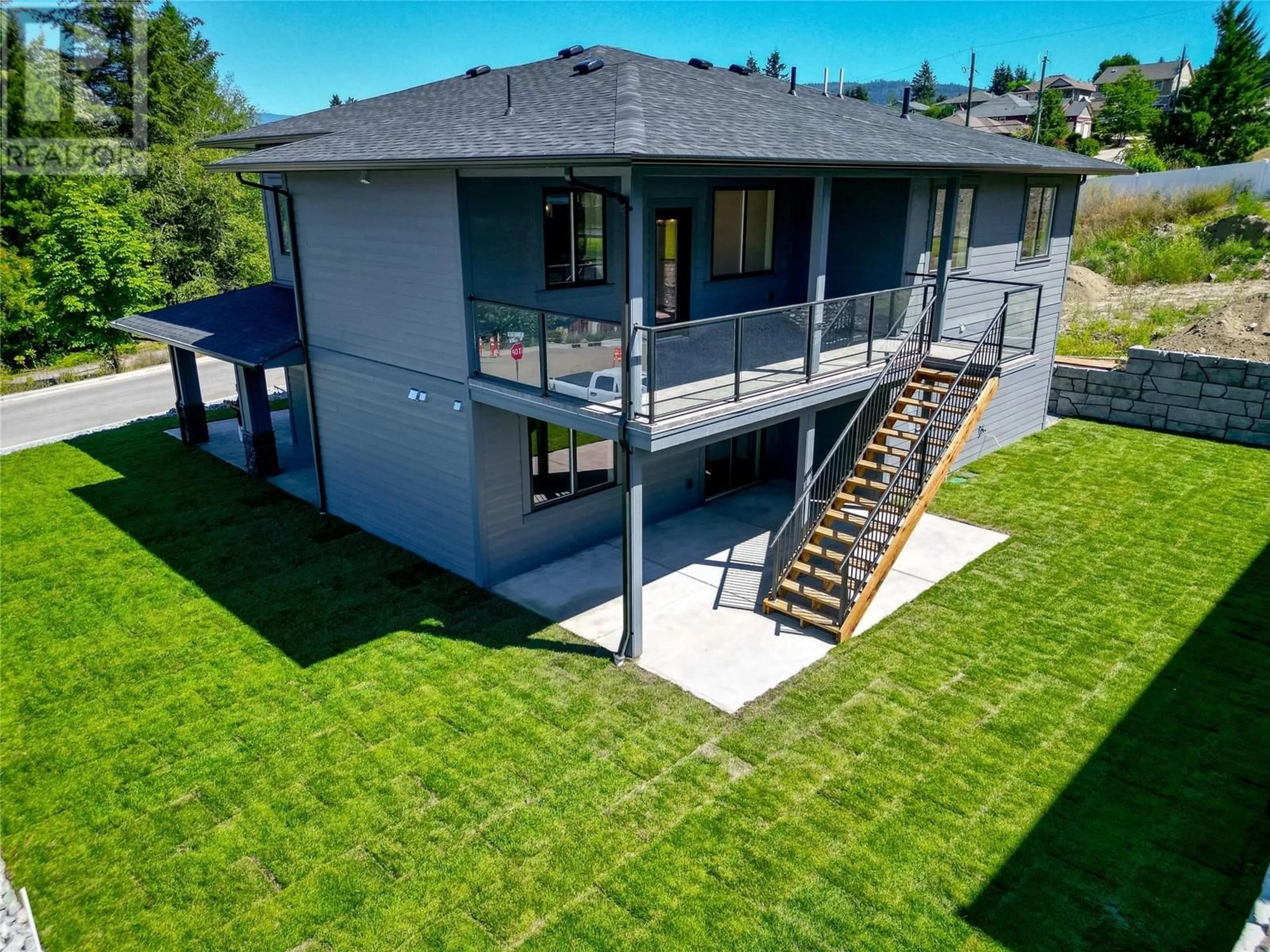 Frontside or backside of a home, the fenced backyard for 960 15 Avenue SE, Salmon Arm British Columbia V1E2G4