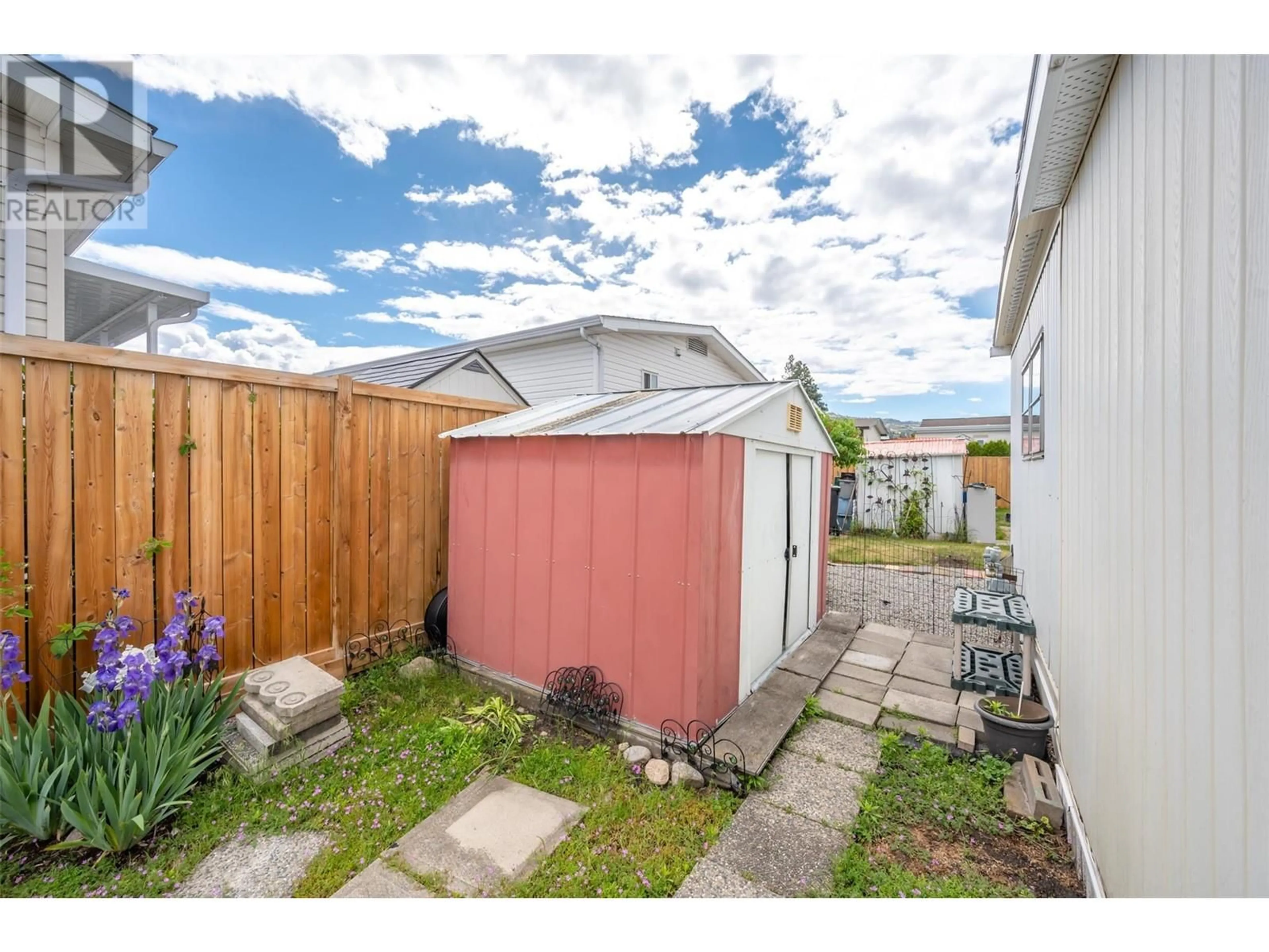 Frontside or backside of a home, the fenced backyard for 98 Okanagan Ave E Avenue Unit# 51, Penticton British Columbia V2A3J5