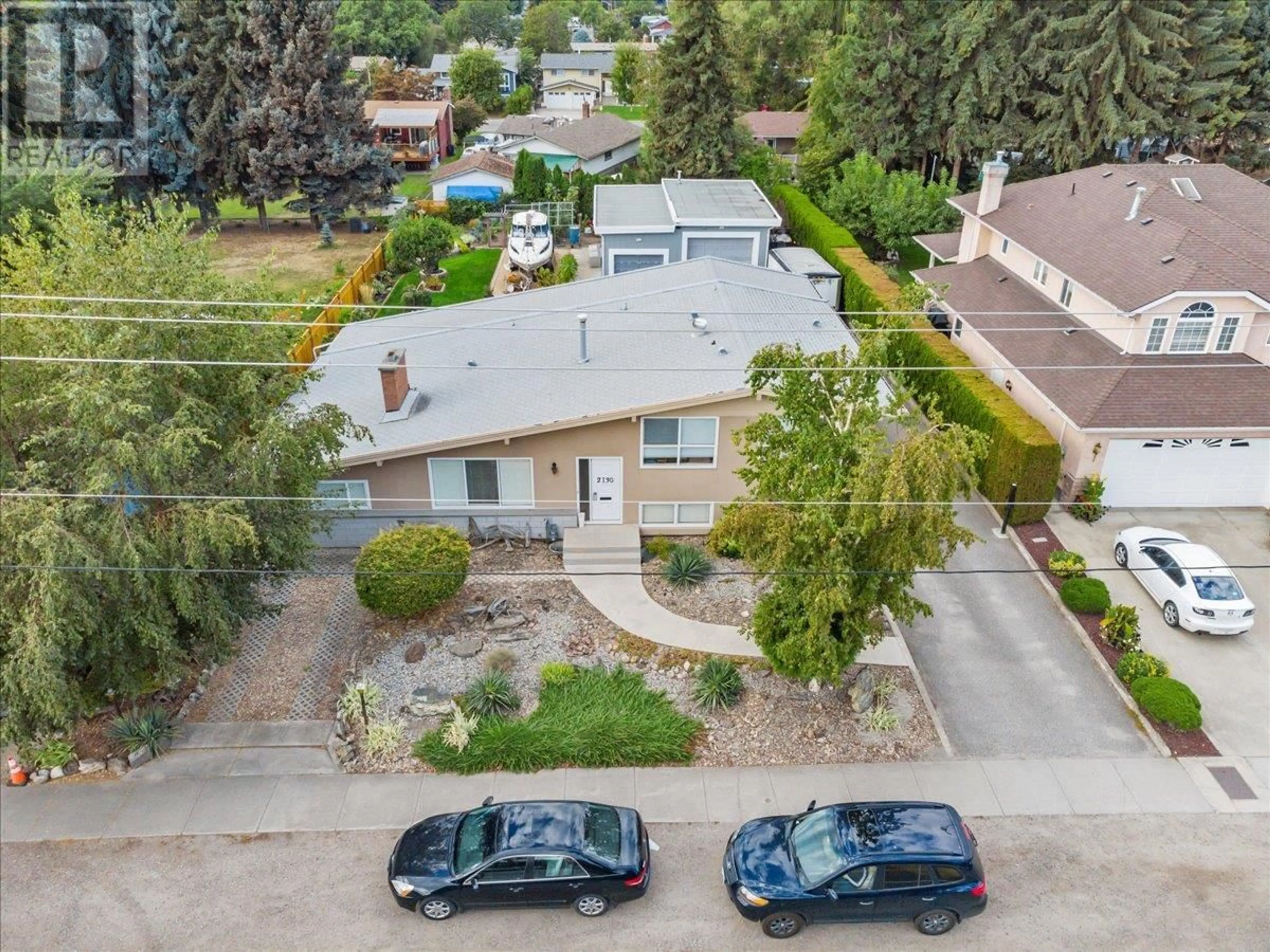 A pic from outside/outdoor area/front of a property/back of a property/a pic from drone, street for 2130 BURTCH ROAD, Kelowna British Columbia V1Y4B5
