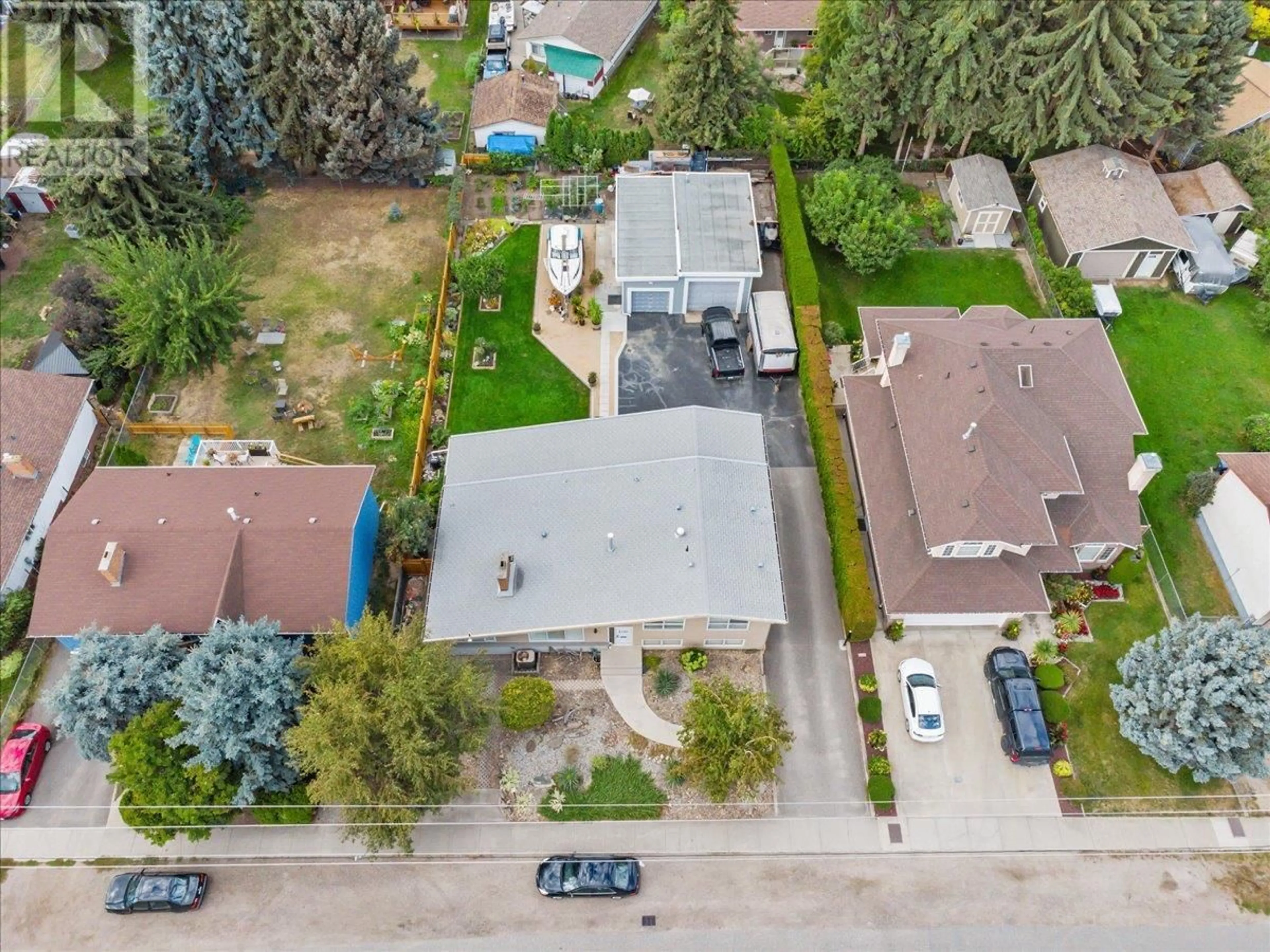 A pic from outside/outdoor area/front of a property/back of a property/a pic from drone, street for 2130 BURTCH ROAD, Kelowna British Columbia V1Y4B5