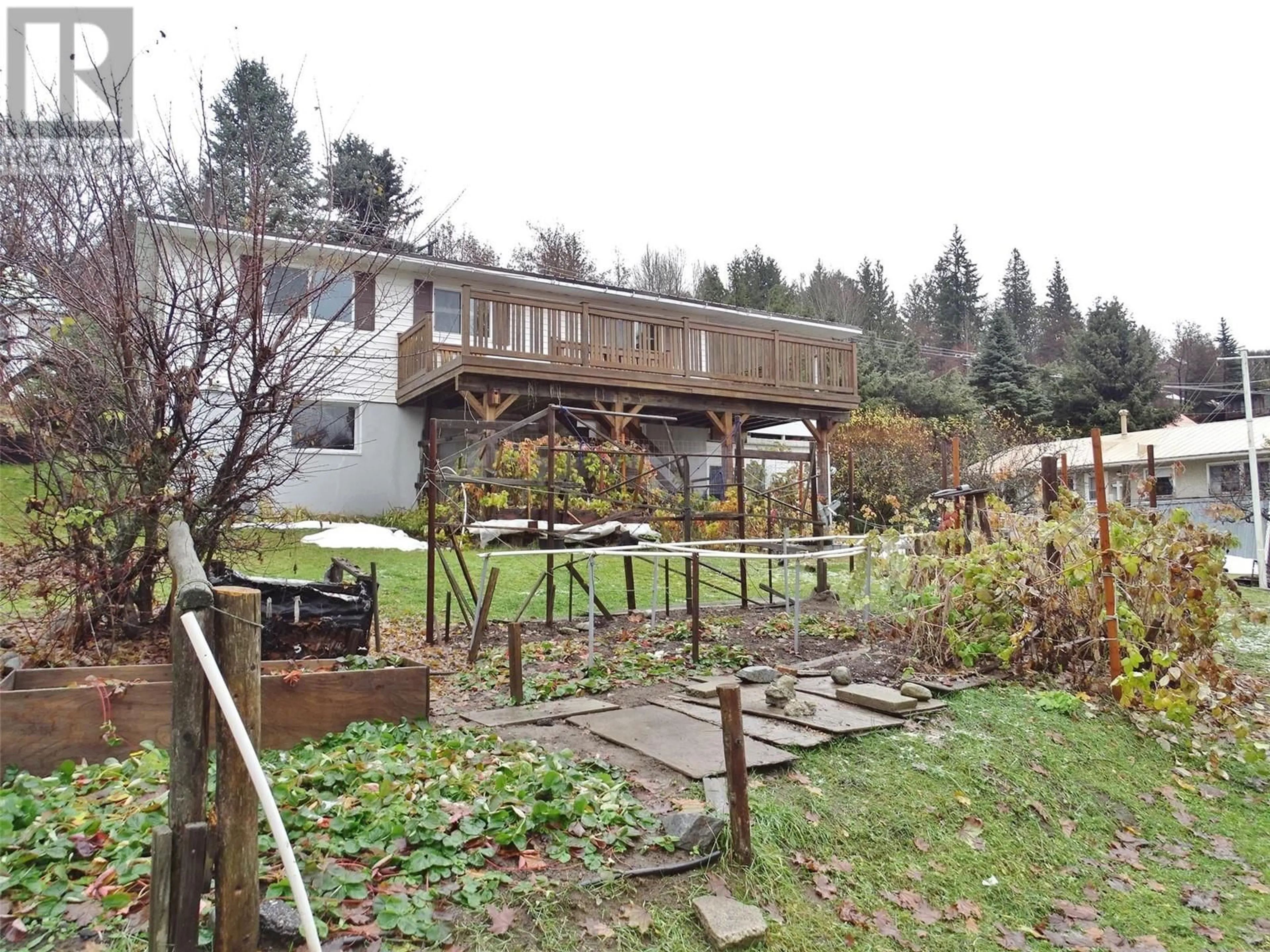 Frontside or backside of a home, the fenced backyard for 2057 Cook Avenue, Rossland British Columbia V0G1Y0