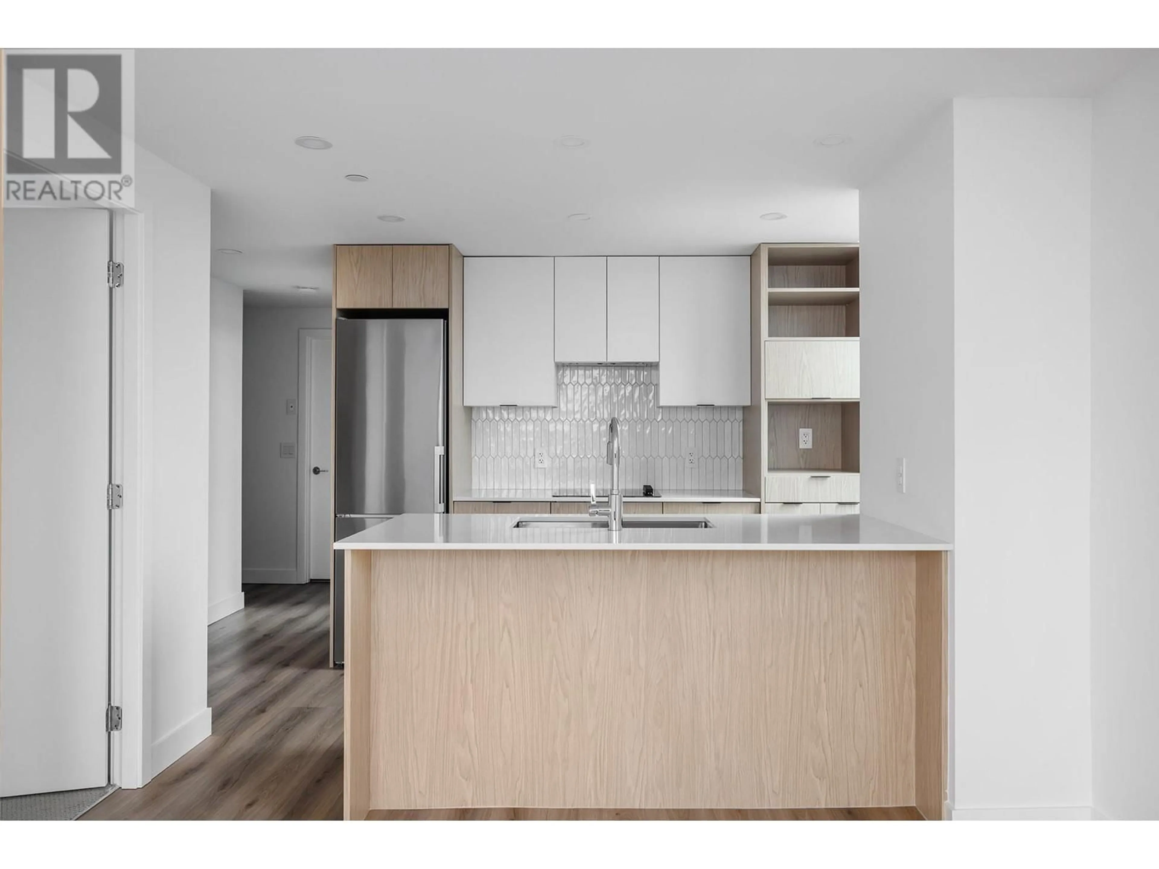 Open concept kitchen, wood/laminate floor for 2905 - 1488 BERTRAM STREET, Kelowna British Columbia V1Y0M6