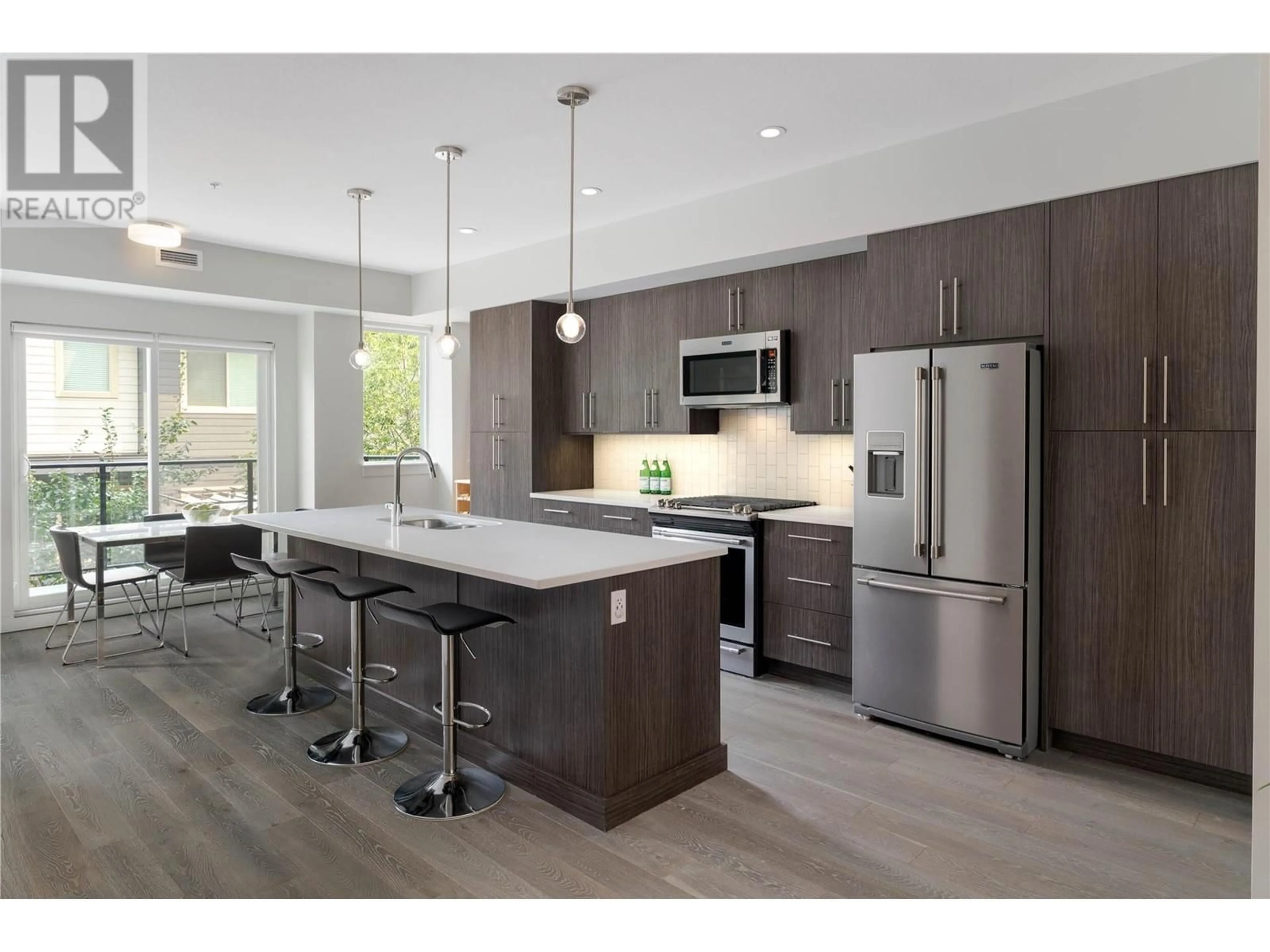 Open concept kitchen, wood/laminate floor for 108 - 3630 MISSION SPRINGS DRIVE, Kelowna British Columbia V1W0B2
