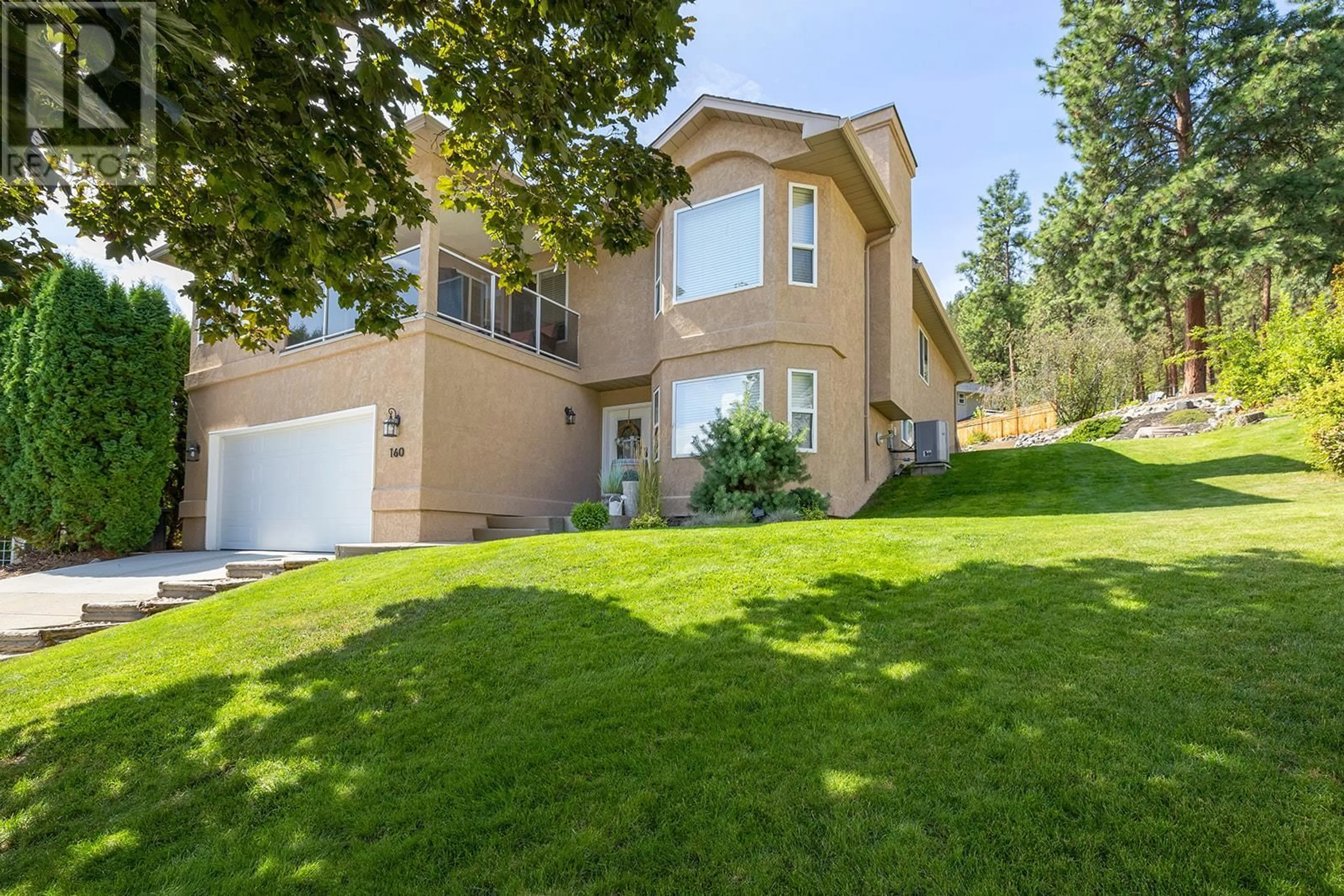 Frontside or backside of a home, the fenced backyard for 160 Portview Court, Kelowna British Columbia V1V1T9