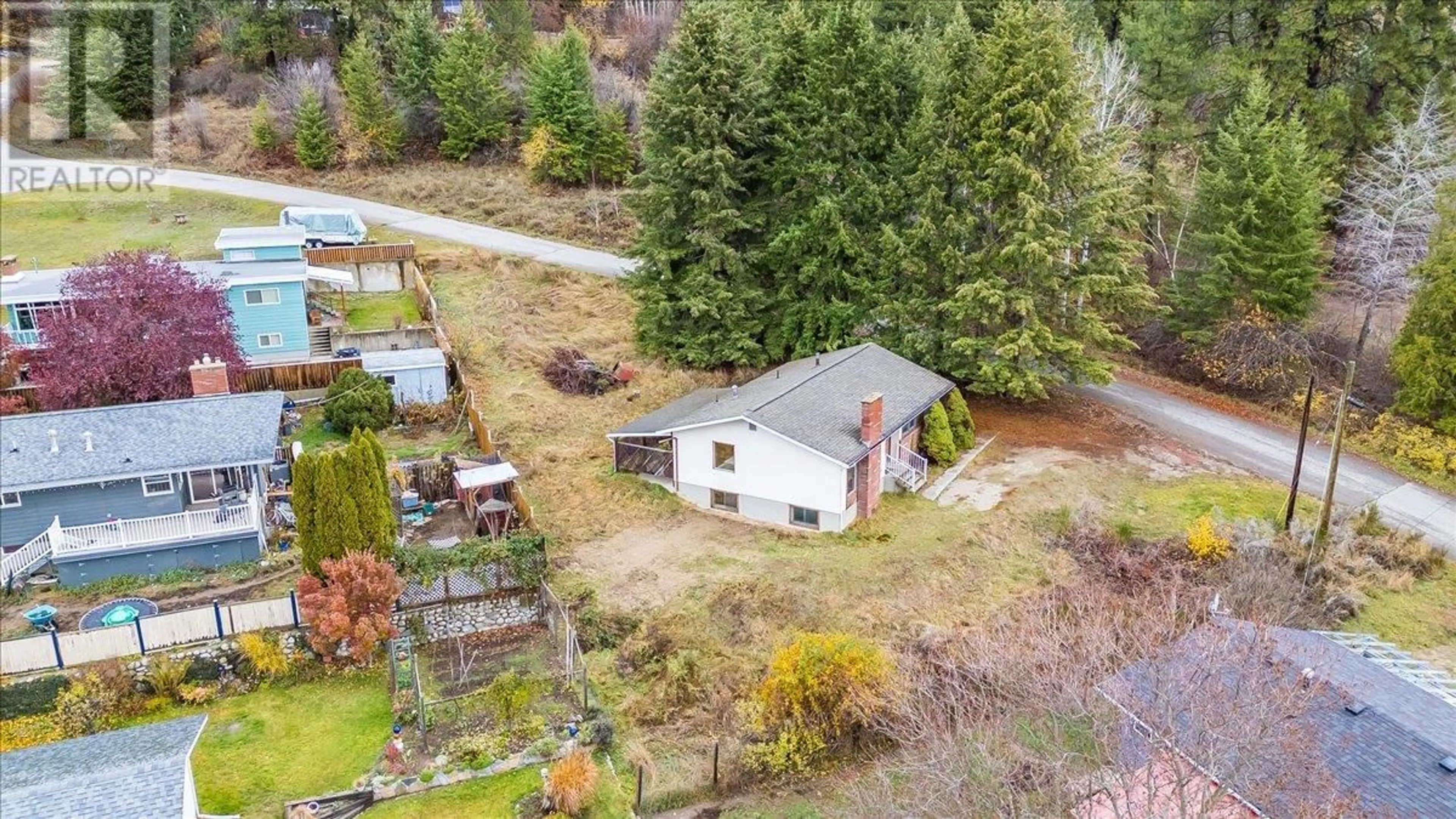 Frontside or backside of a home, the fenced backyard for 1110 McDiarmid Road, Castlegar British Columbia V1N4V8