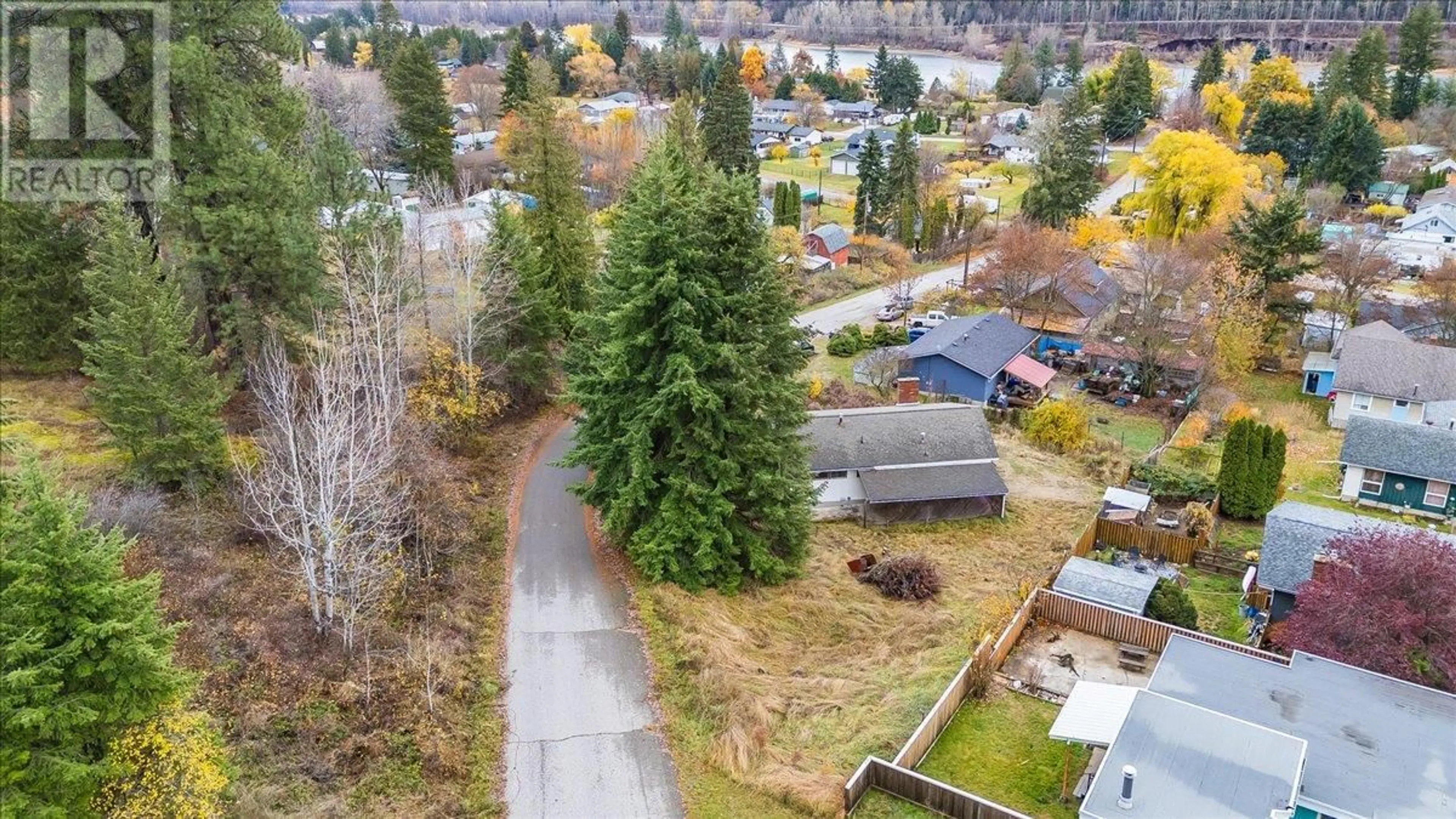 A pic from exterior of the house or condo, the fenced backyard for 1110 McDiarmid Road, Castlegar British Columbia V1N4V8