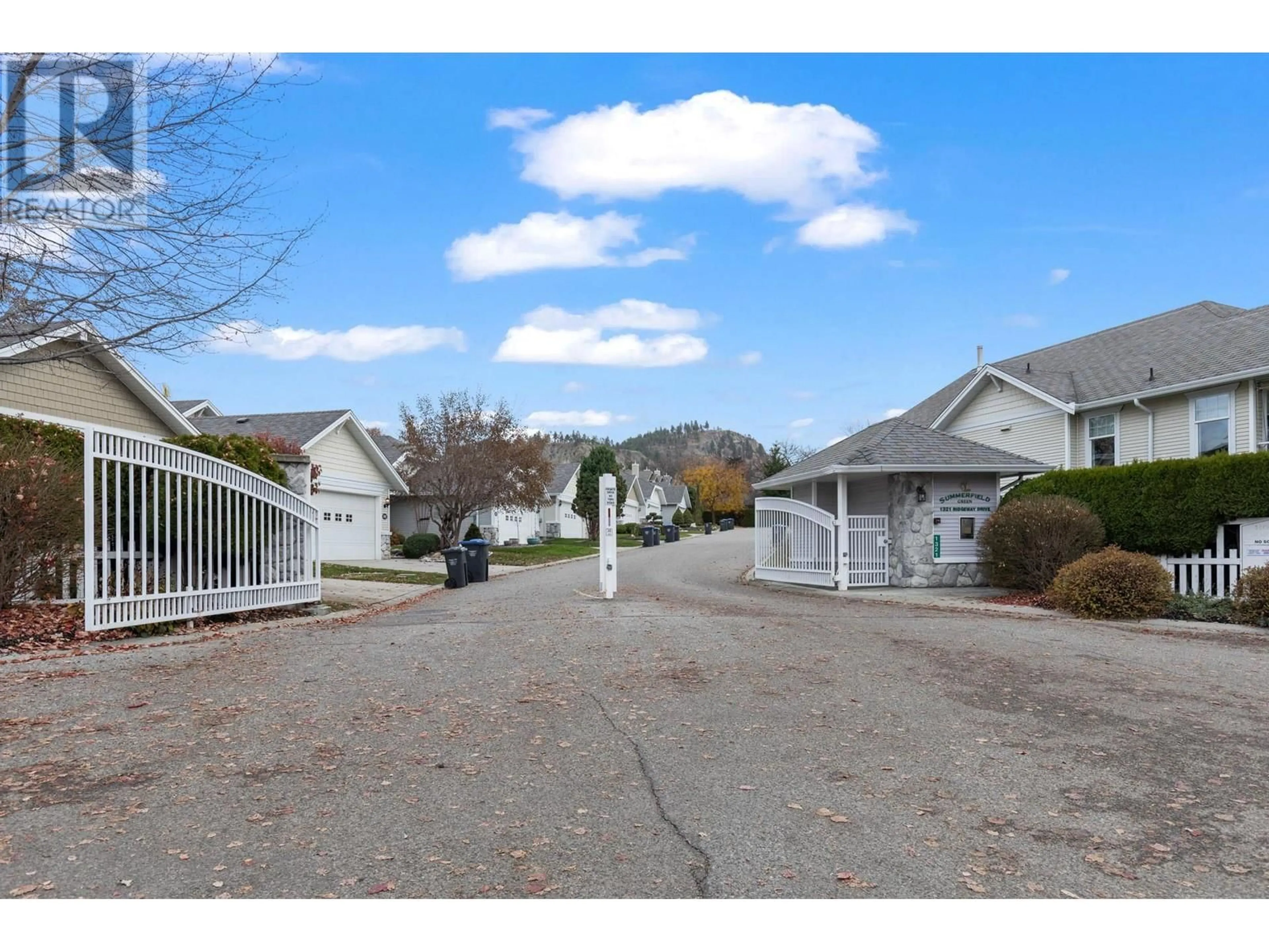 A pic from exterior of the house or condo, the fenced backyard for 1321 Ridgeway Drive Unit# 117, Kelowna British Columbia V1Y9T6